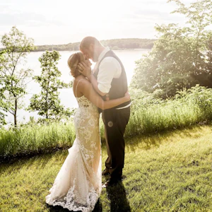 Bride with groom wearing romantic lace sheath wedding dress