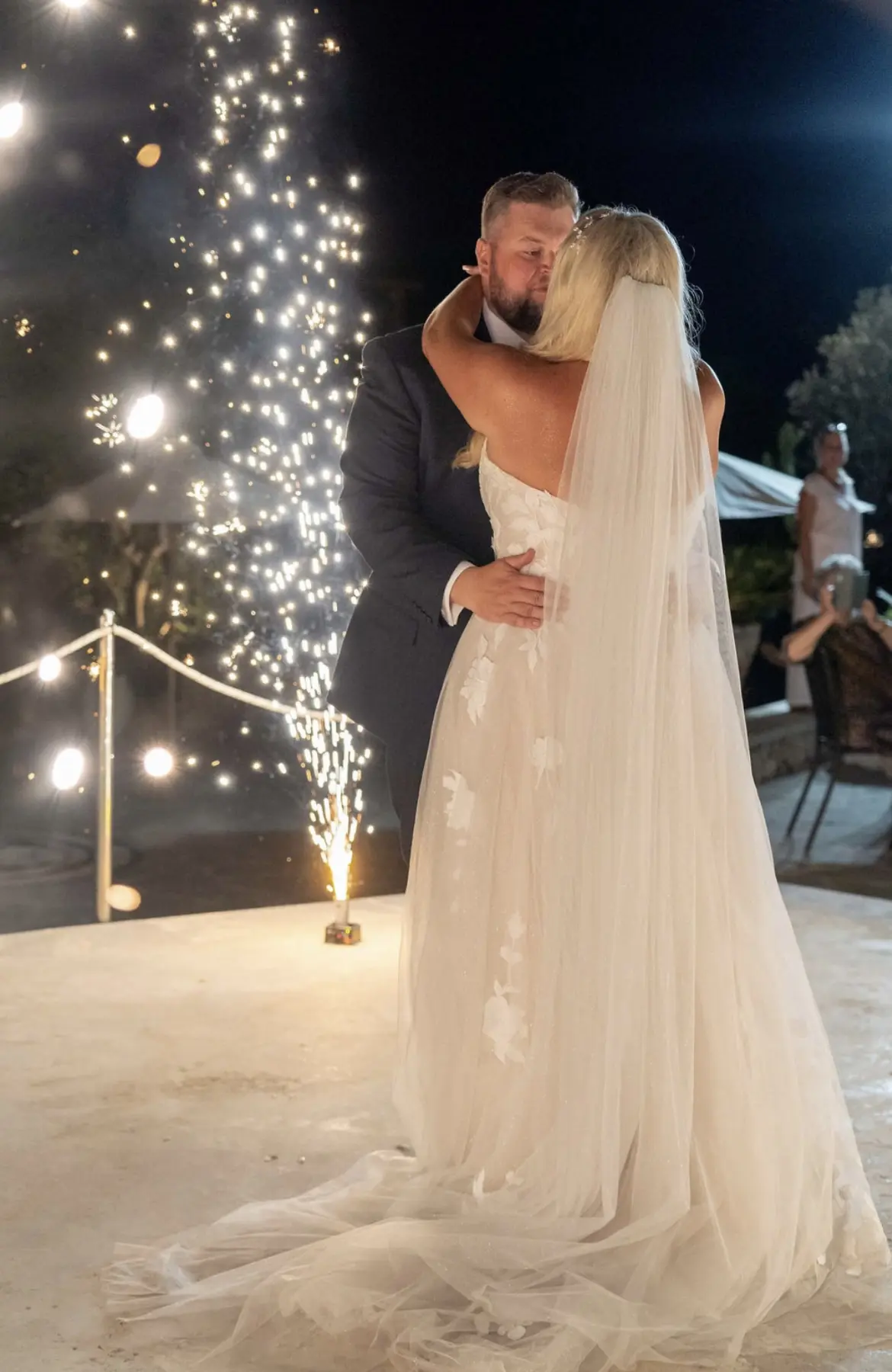 Groom Dancing with Bride by Sparkler Wearing Sexy Wedding Gown Called Hattie Lane Marie by Rebecca Ingram.