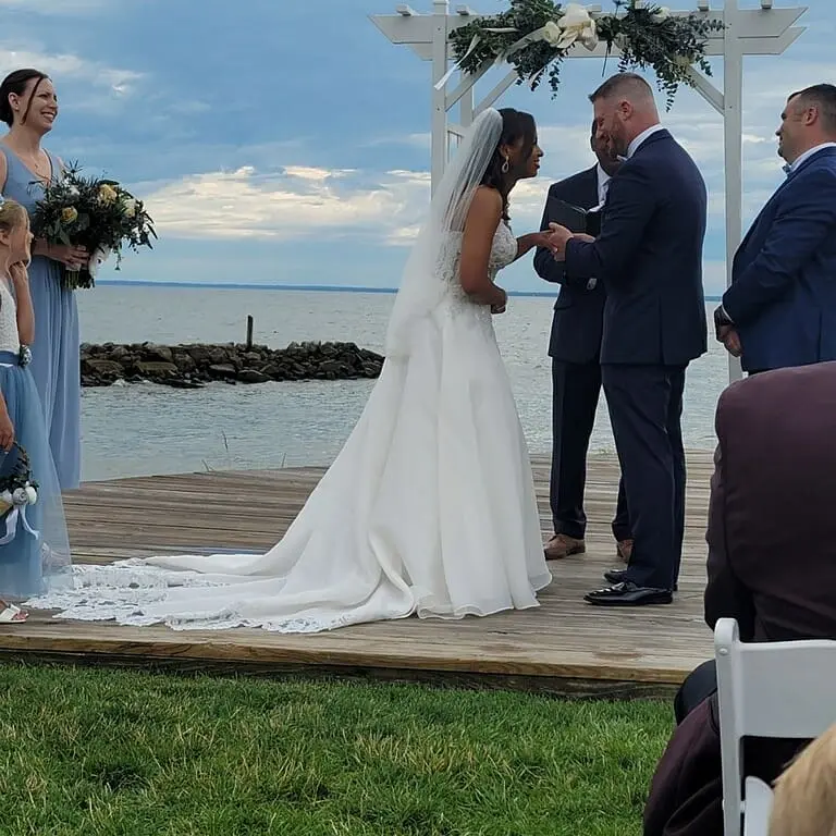 Bride Wearing Flirty A-line Wedding Gown Called Savannah By Maggie Sottero And Groom Exchanging Rings