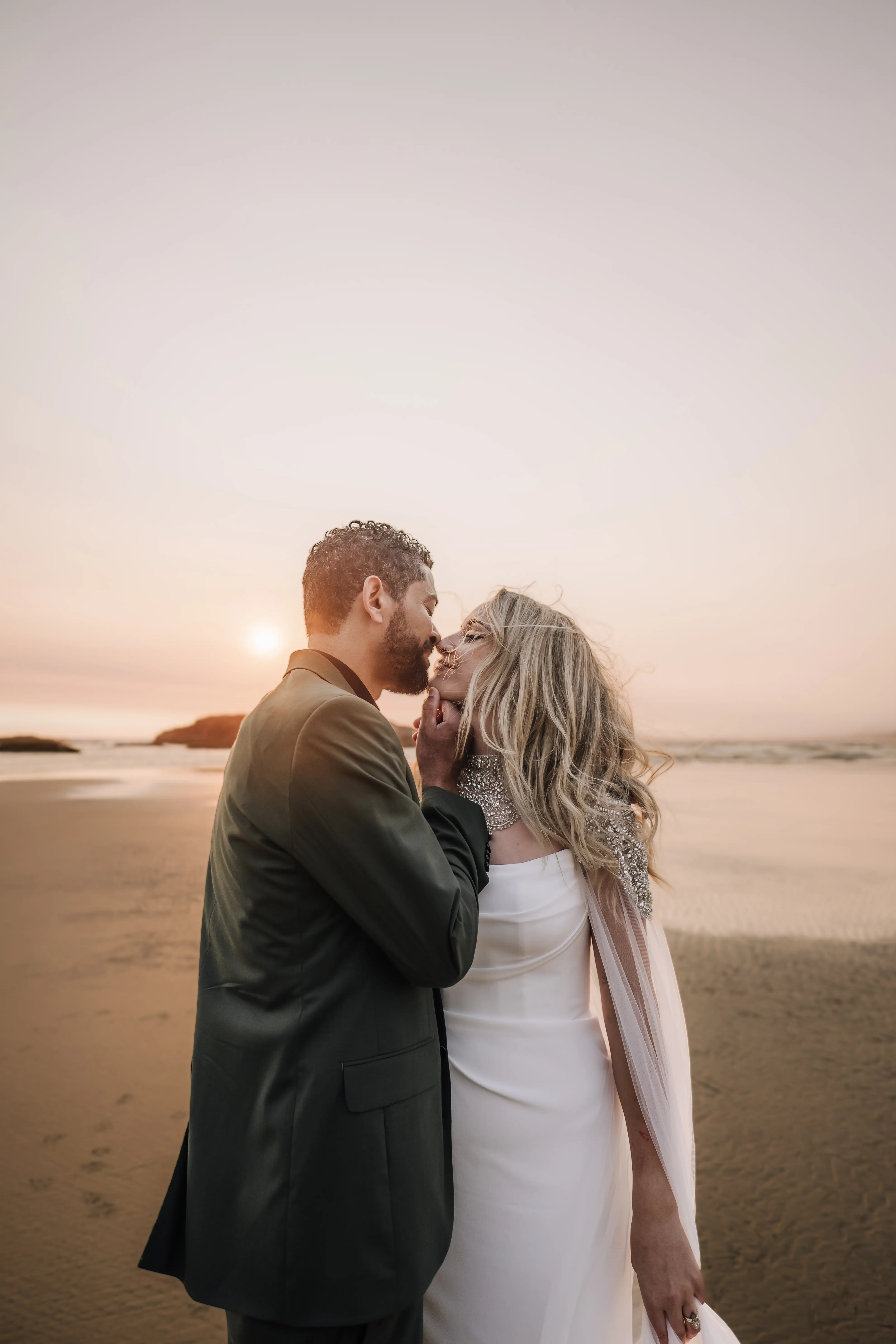 Bride wearing Summer wedding dress by Maggie Sottero kissing the groom