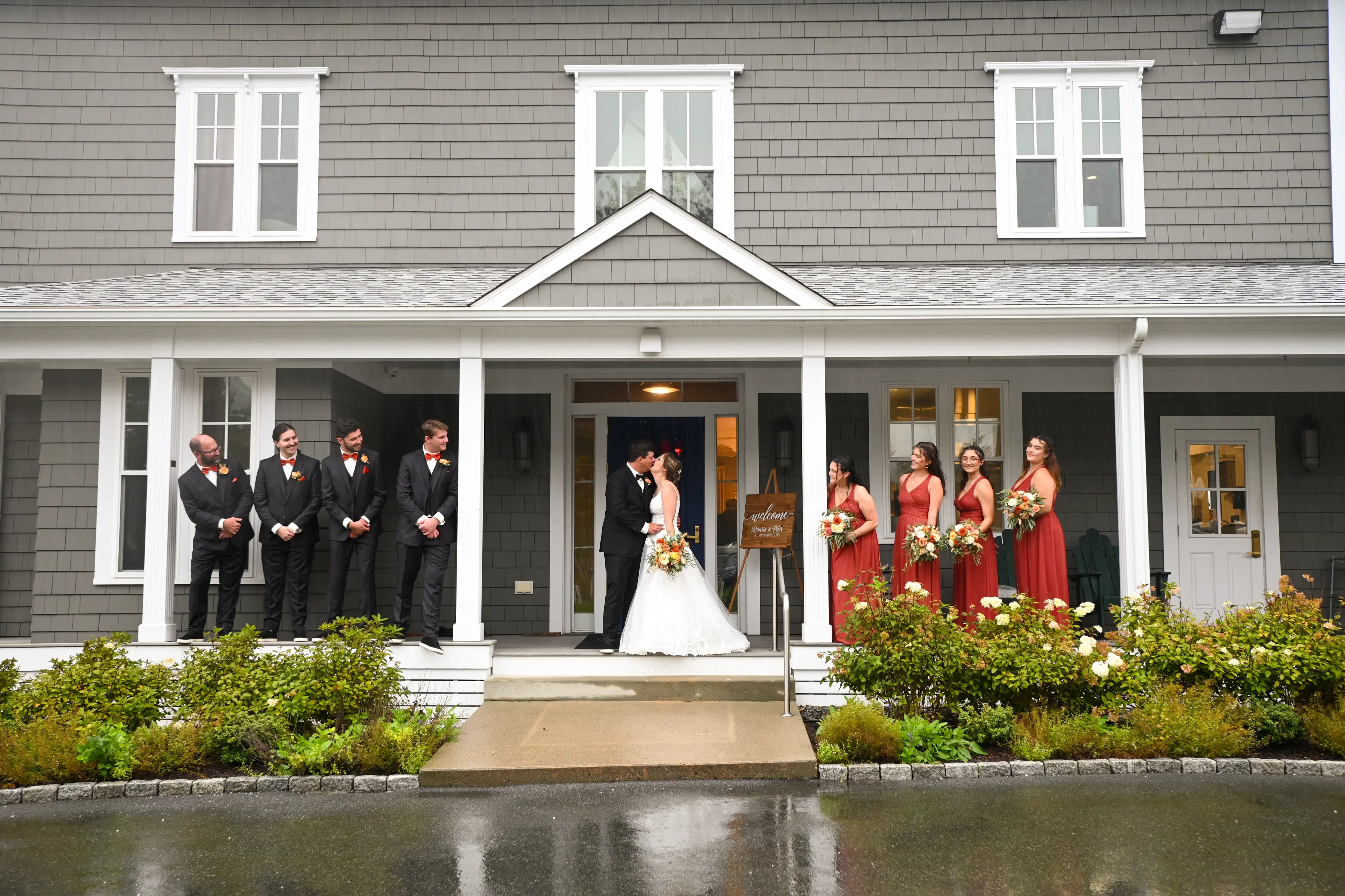 Bride wearing Florence wedding dress by Maggie Sottero kissing her husband with wedding party