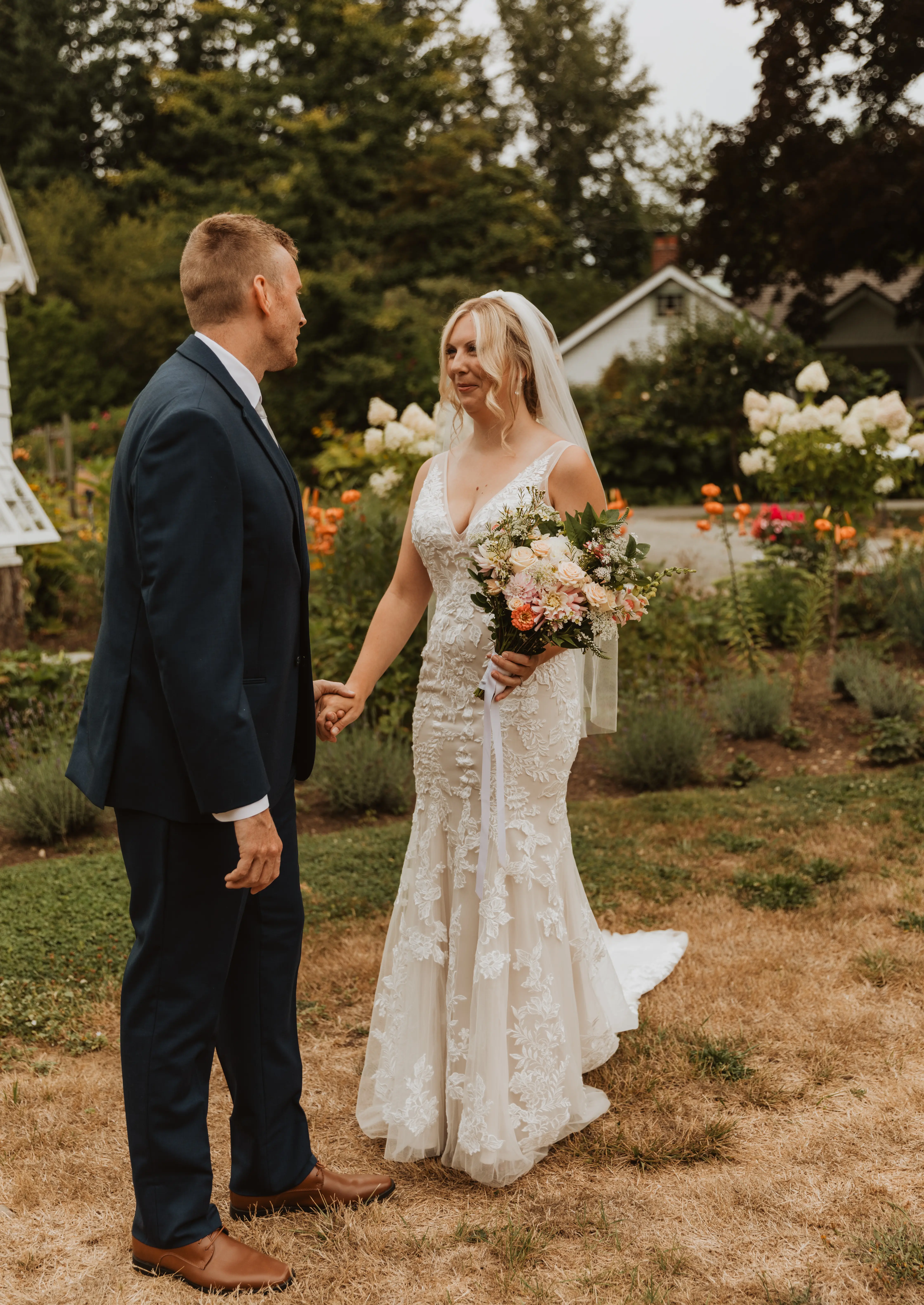 Bride wearing Greenley wedding dress by Maggie Sottero holding hands with her husband