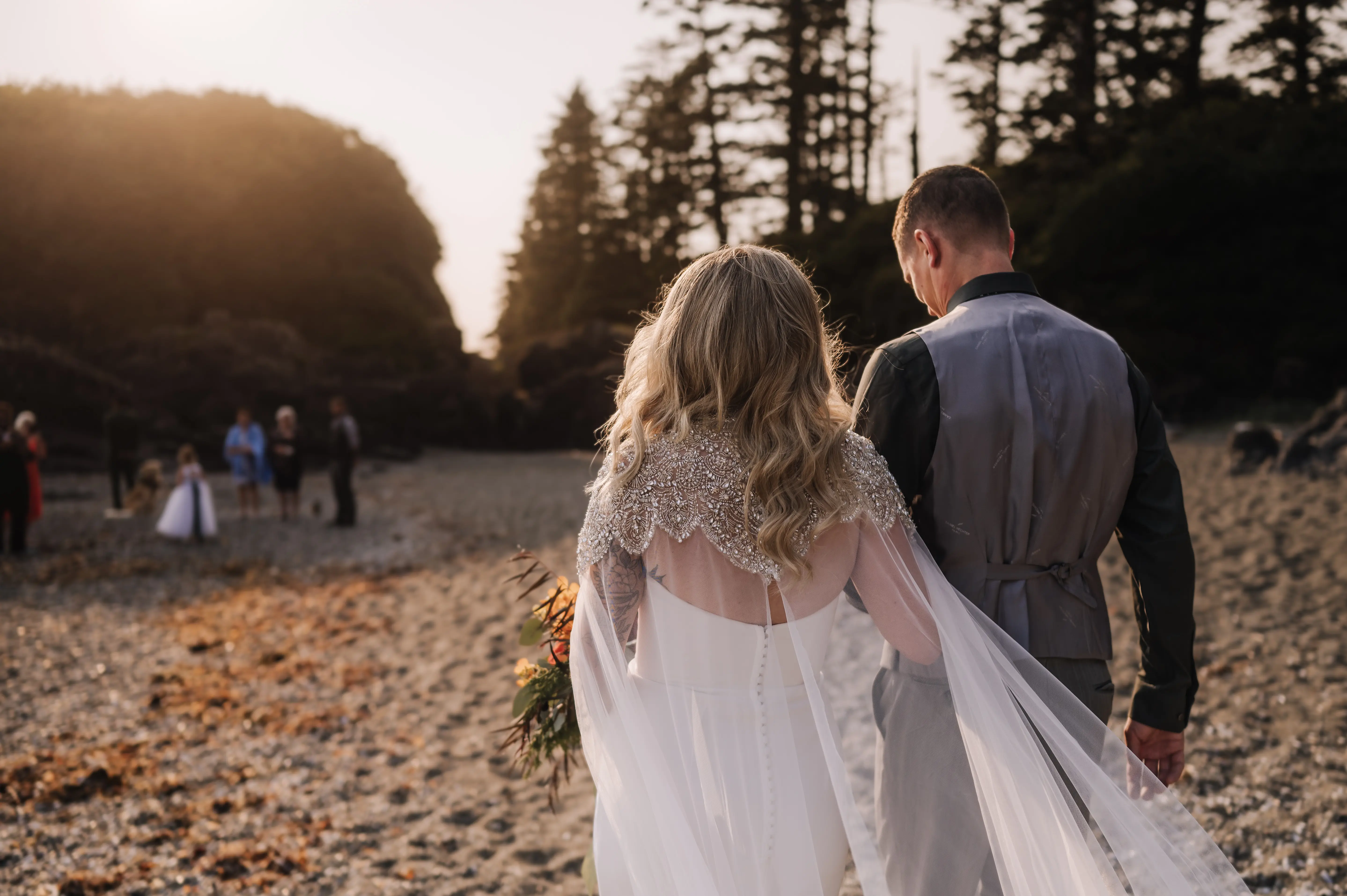 Bride wearing Summer wedding dress by Maggie Sottero walking with her husband