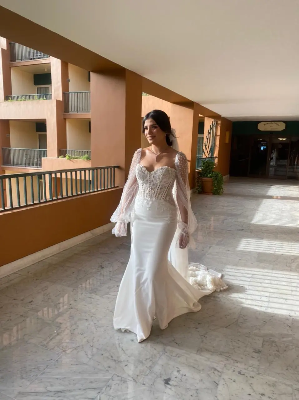 Bride Wearing Sheath and Beaded Wedding Dress Called Doritte By Maggie Sottero Walking