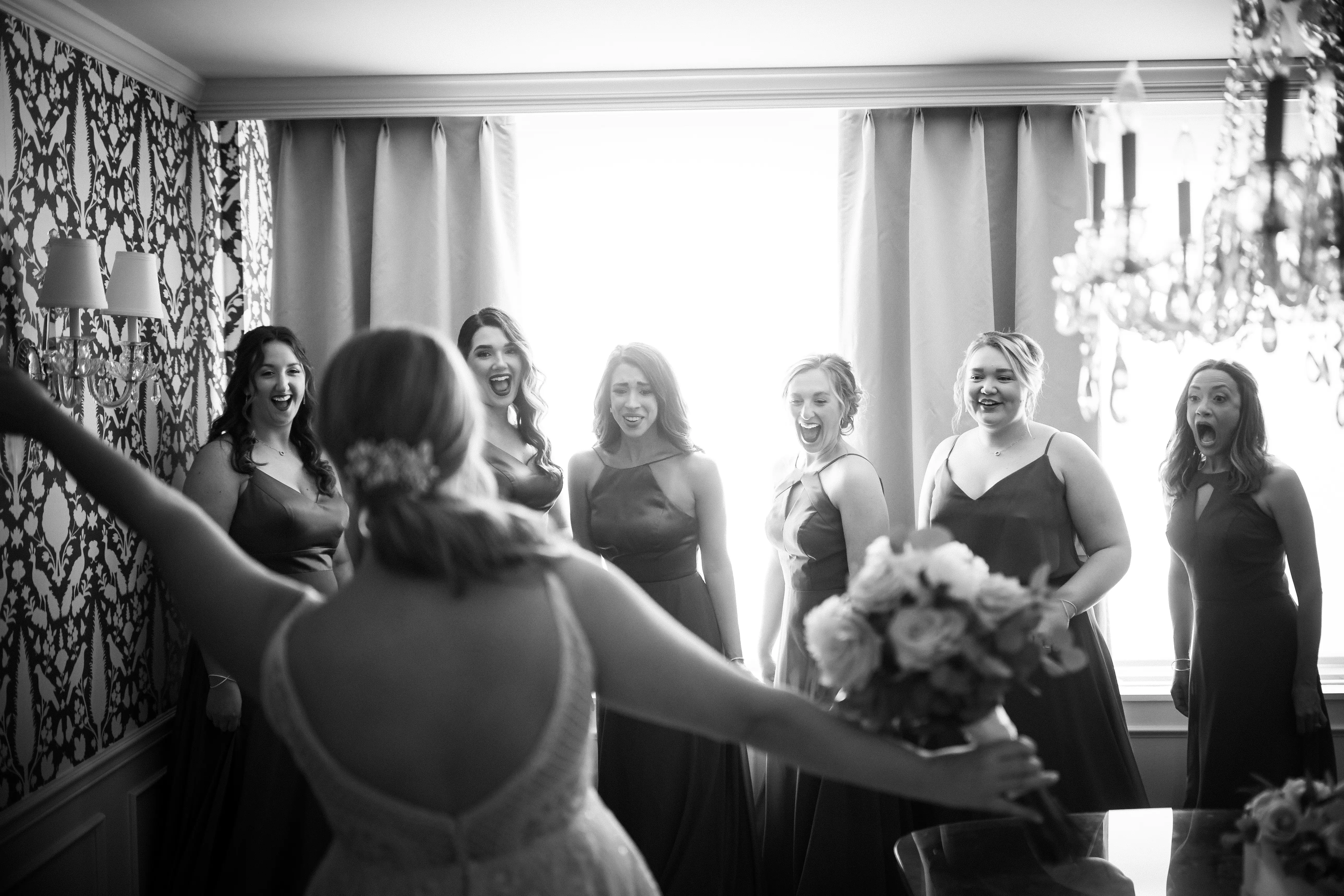 Bride Wearing Glam Princess A-Line Wedding Dress Called Roxanne By Sottero And Midgley Showing Her Dress to Her Bridesmaids