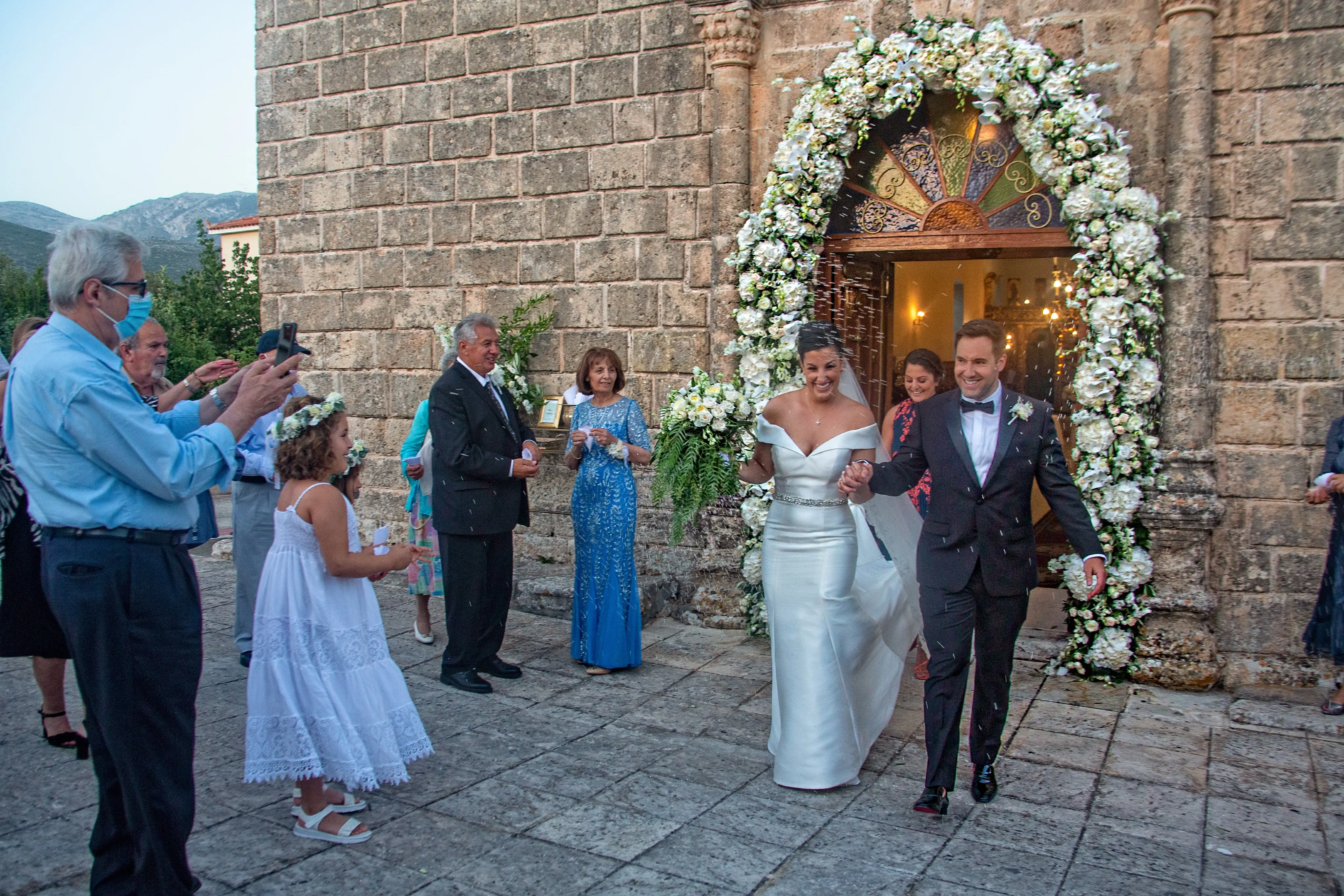 Bride wearing Simple Fit-and-Flare Wedding Dress called Josie by Rebecca Ingram leaving the chapel