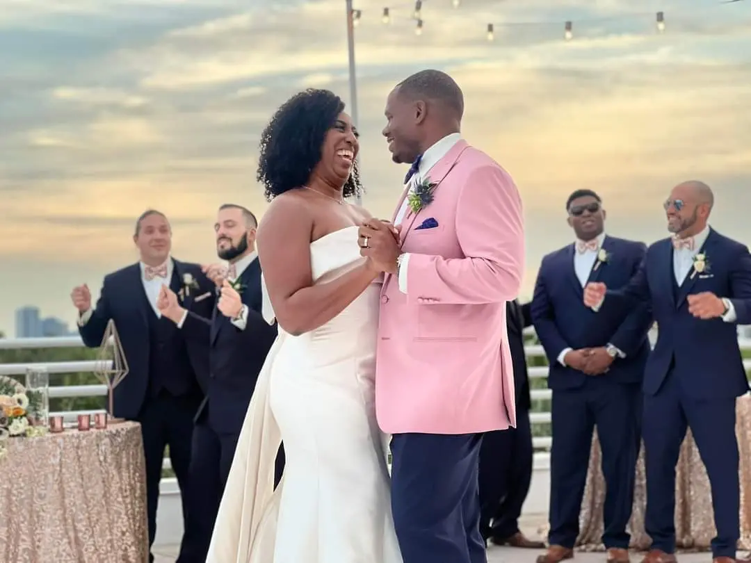 Groom Dancing With Bride In Strapless Chic Wedding Dress Named Mitchell By Maggie Sottero