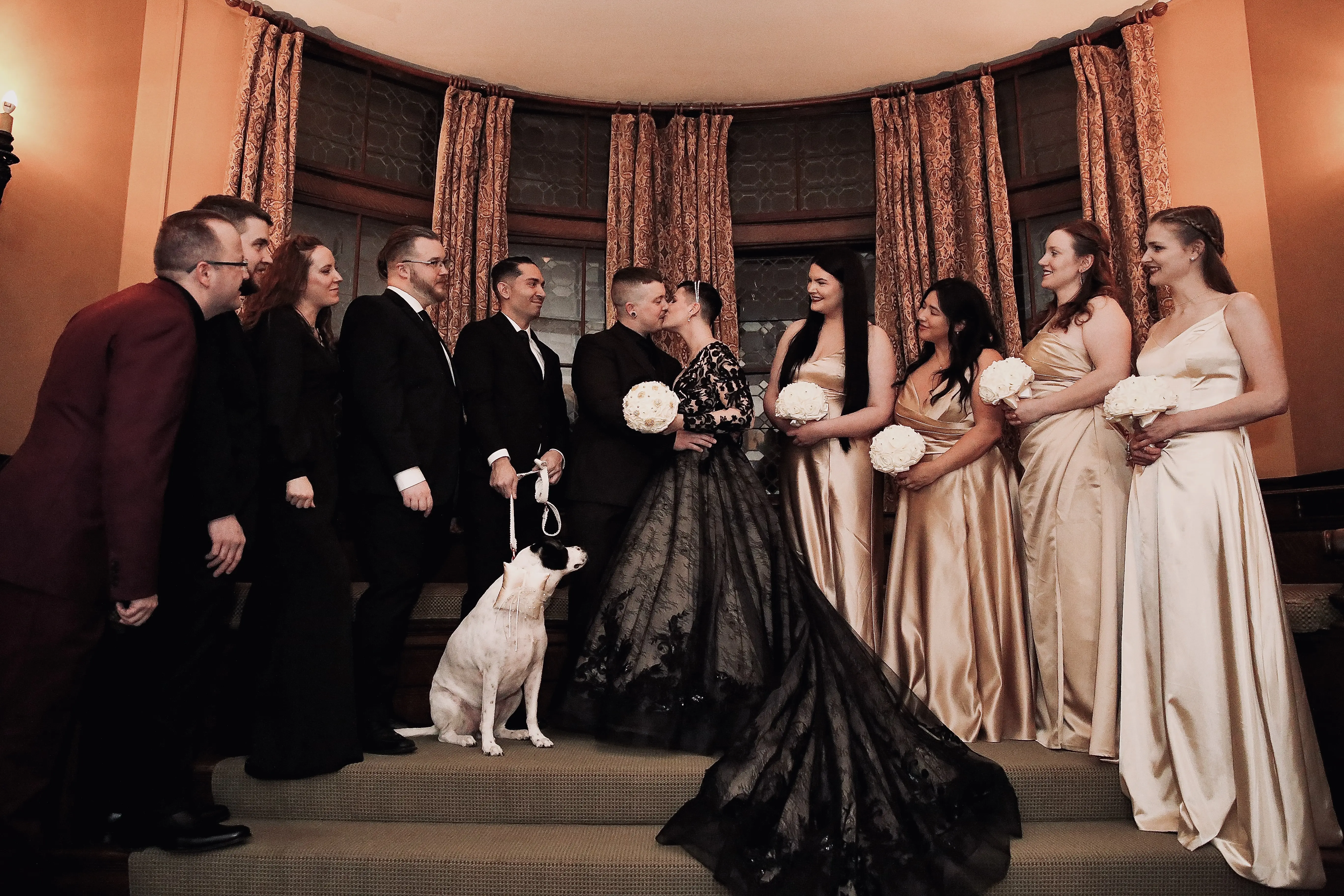 Groom Kissing Bride In Black Wedding Dress Named Zander By Sottero and Midgley Posing With Bridal Party And Dog