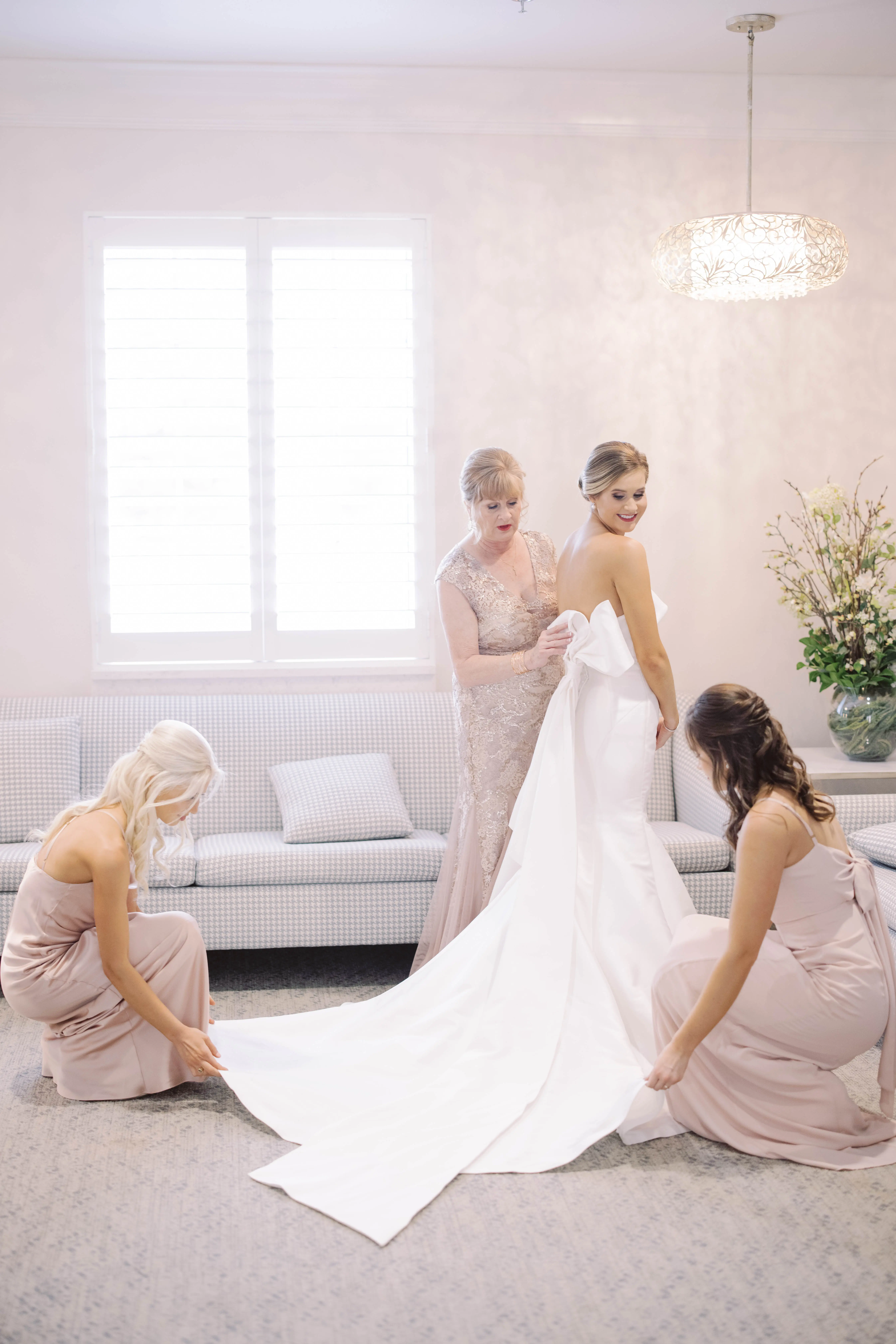 Bride Wearing Simple Sheath Wedding Dress With Bow Back Called Mitchell By Maggie Sottero