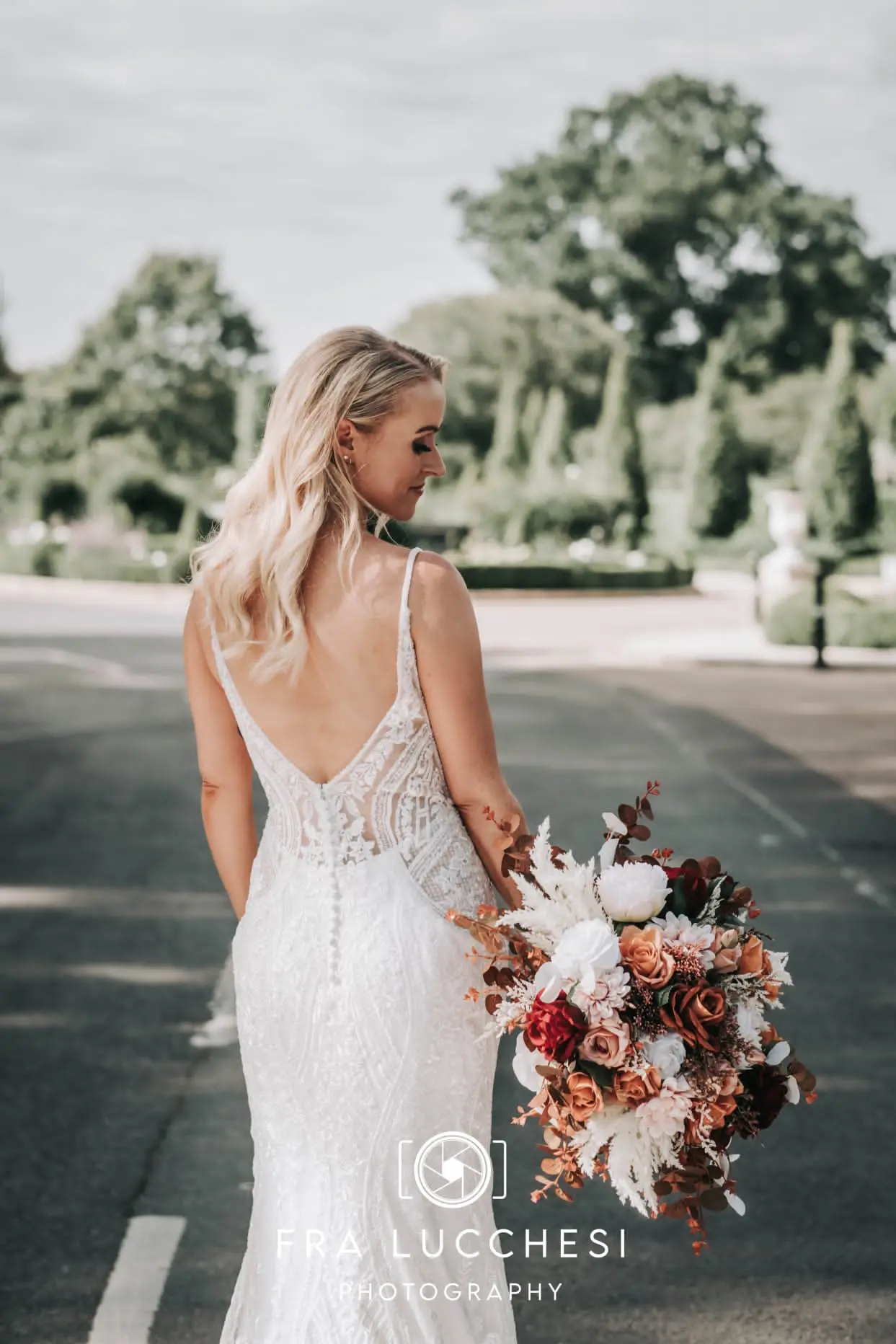Bride wearing Bailey wedding dress by Sottero and Midgley holding a bouquet