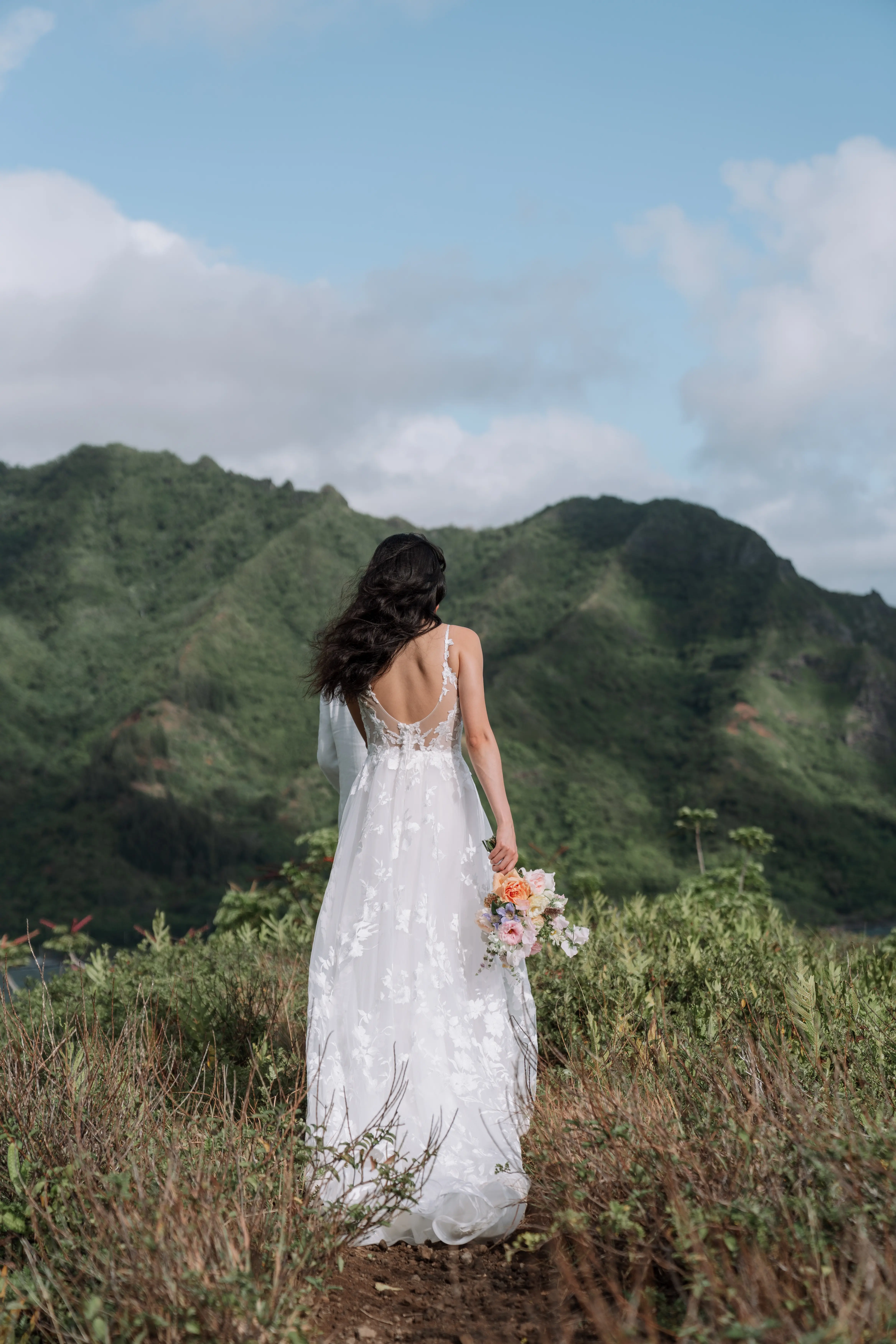 Bride in Winter wedding dress by Maggie Sottero on top of mountain