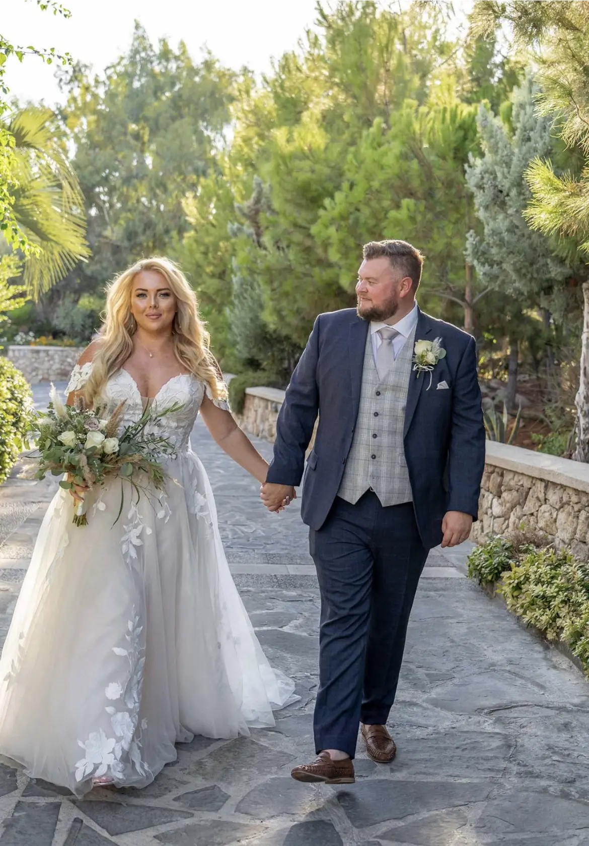 Groom and Bride Holding Hands Wearing Wedding Dress Called Hattie Lane Marie by Rebecca Ingram.