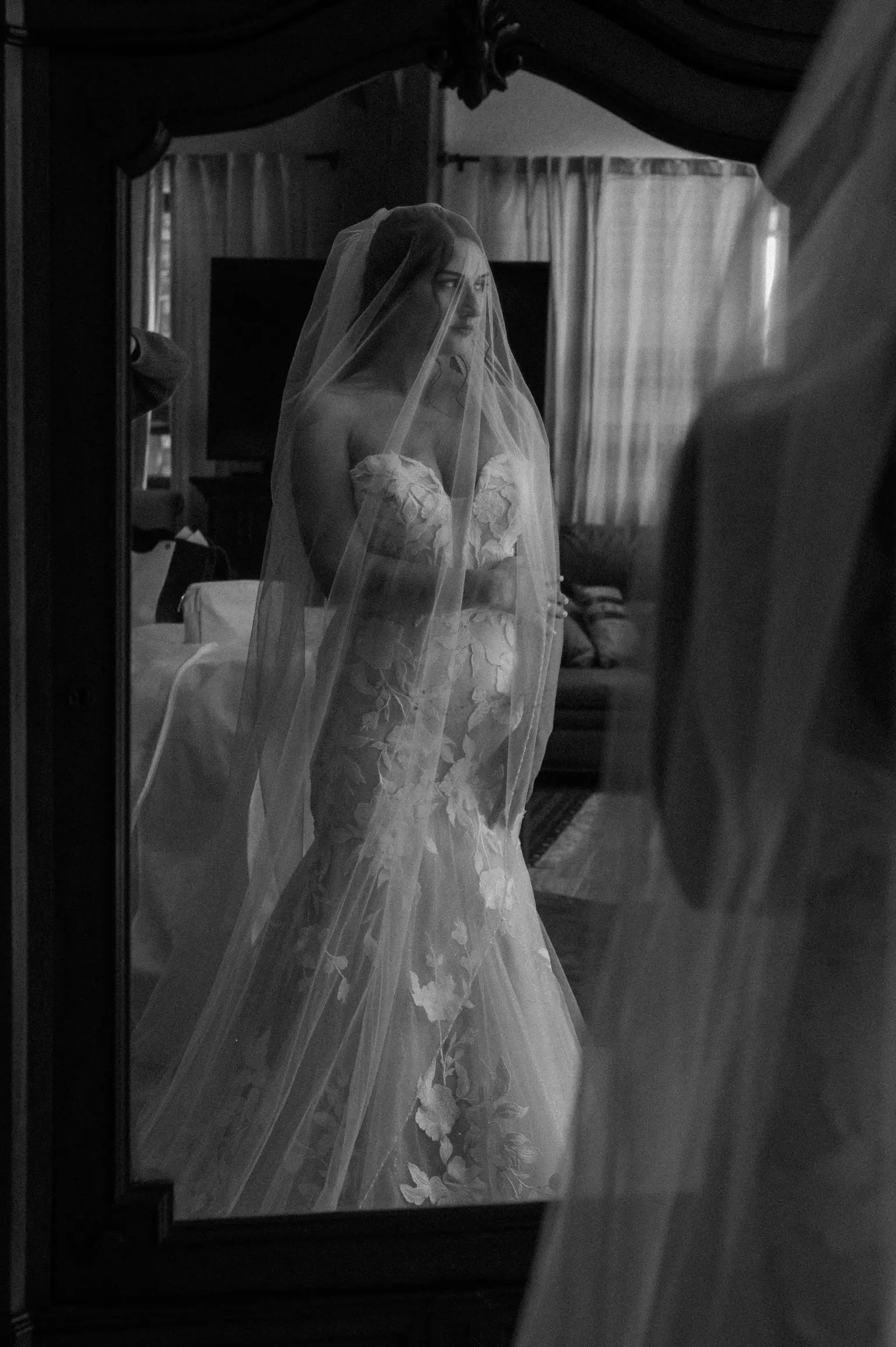 Bride wearing Hattie wedding dress by Rebecca Ingram looking in the mirror