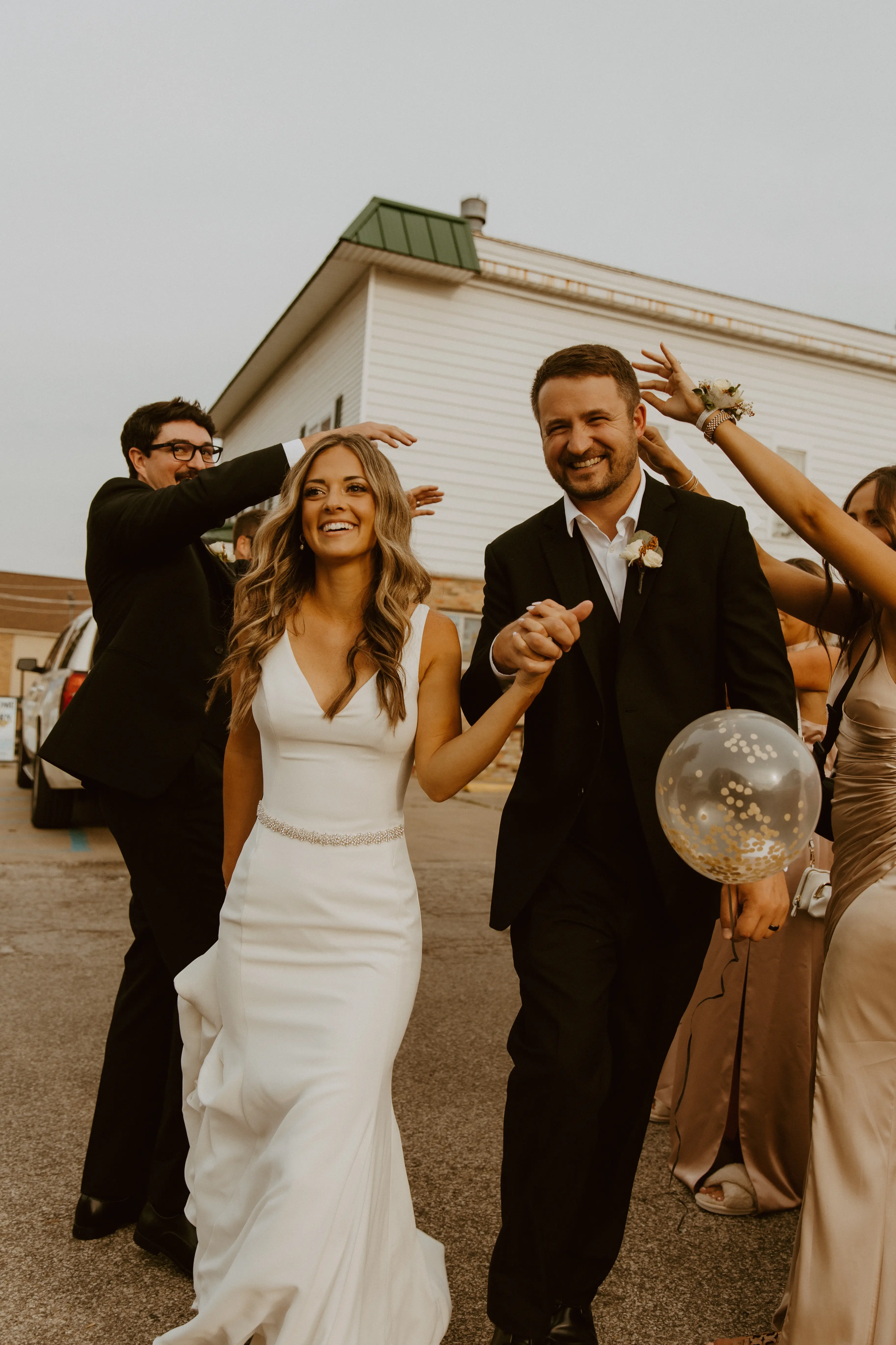 Bride Wearing Simple Fit-and-Flare Wedding Dress Called Fernanda By Maggie Sottero Walking Away With Groom