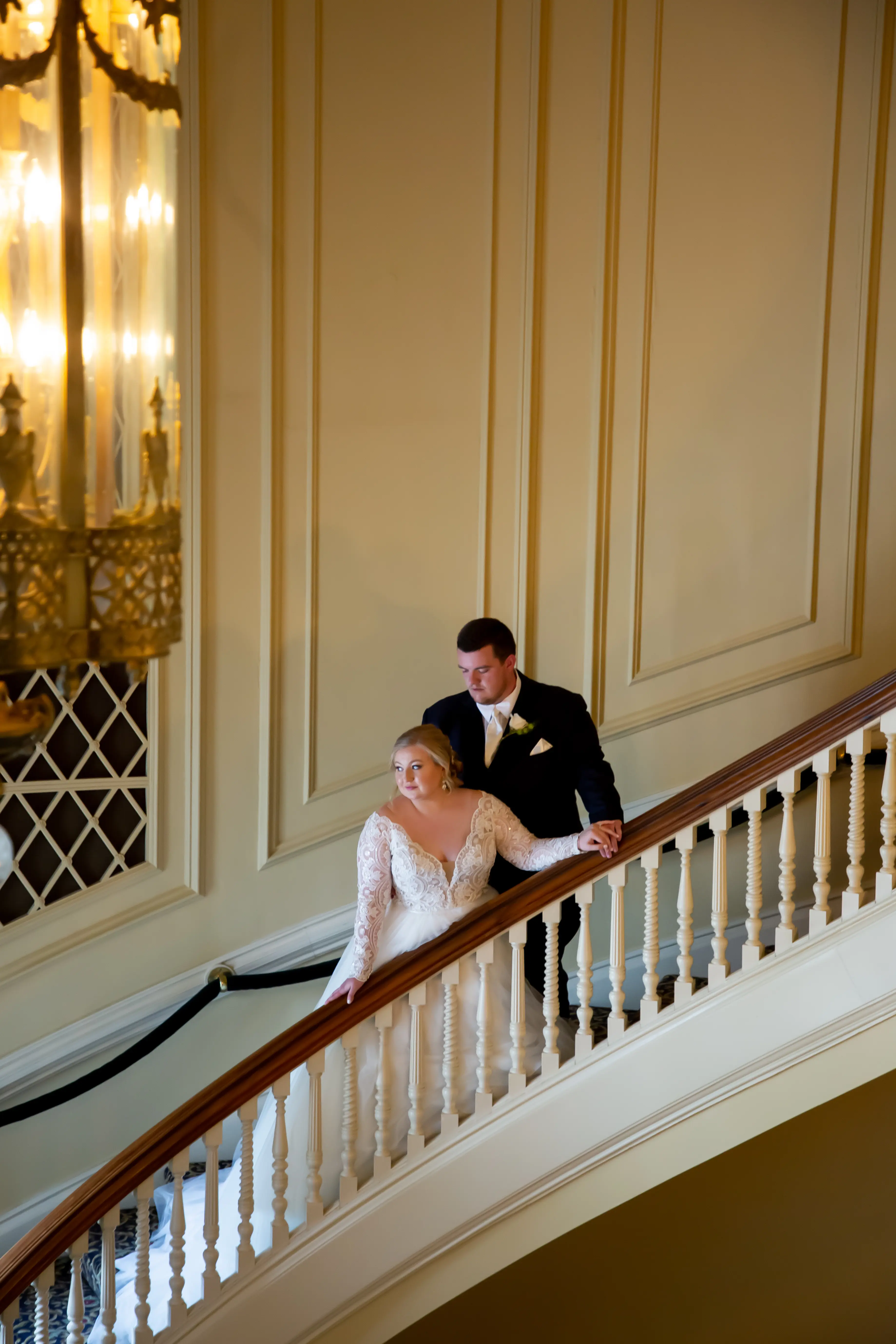 Bride and Groom on Grand Staircase Wearing Bridal Dress Called Mallory Dawn by Maggie Sottero