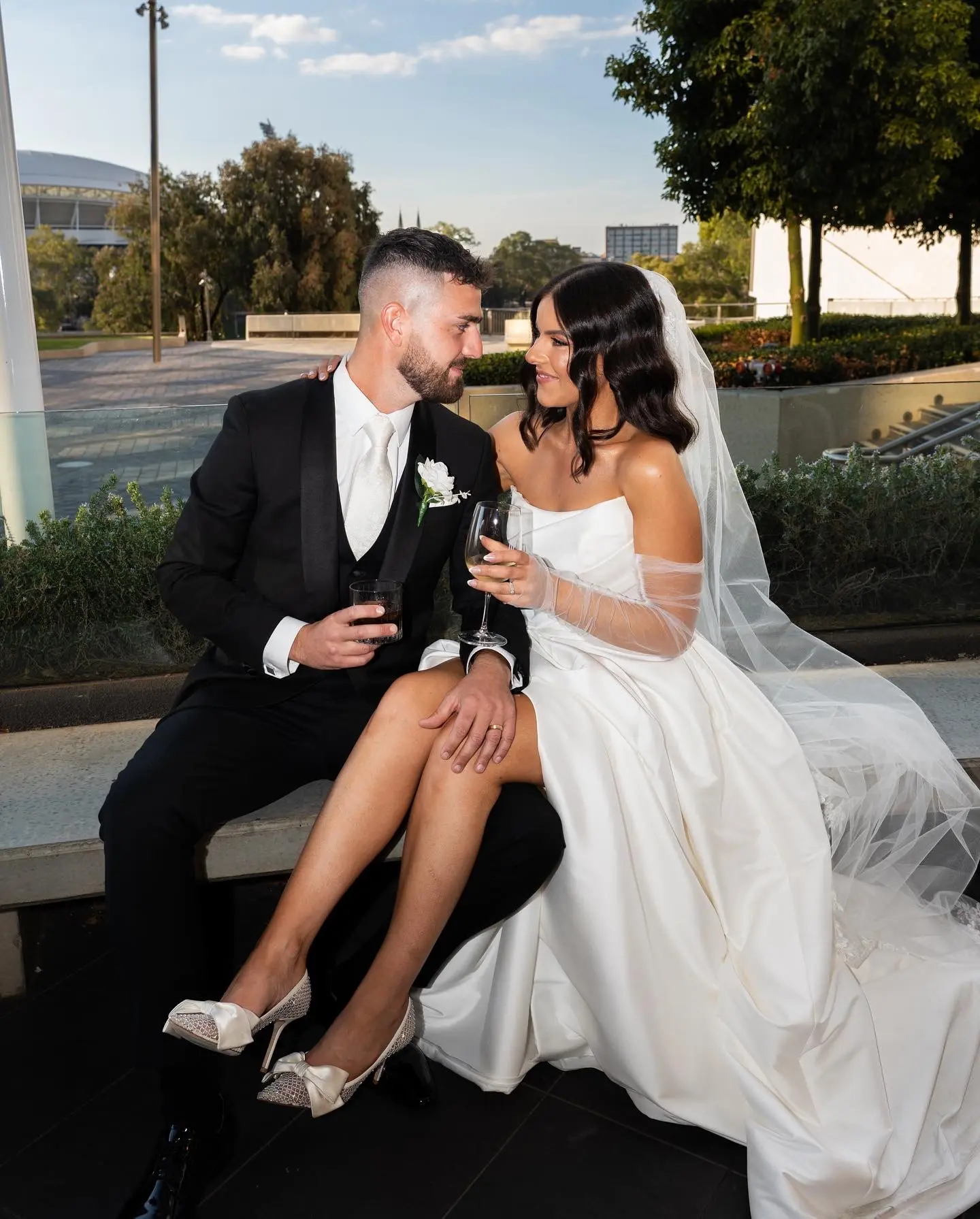 Bride wearing Aspen by Sottero and Midgley drinking with her husband