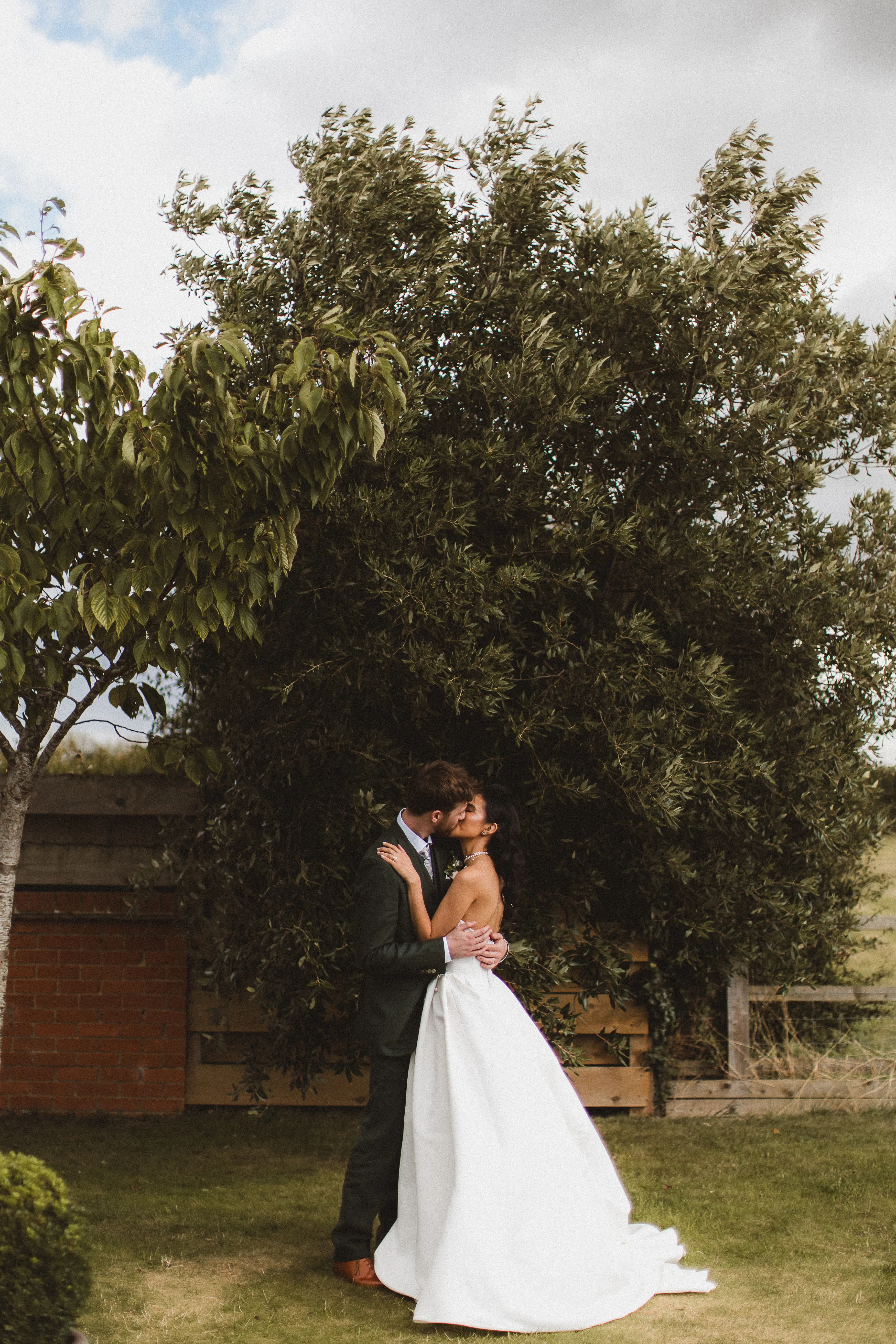 Bride wearing Derrick by Maggie Sottero kissing her husband