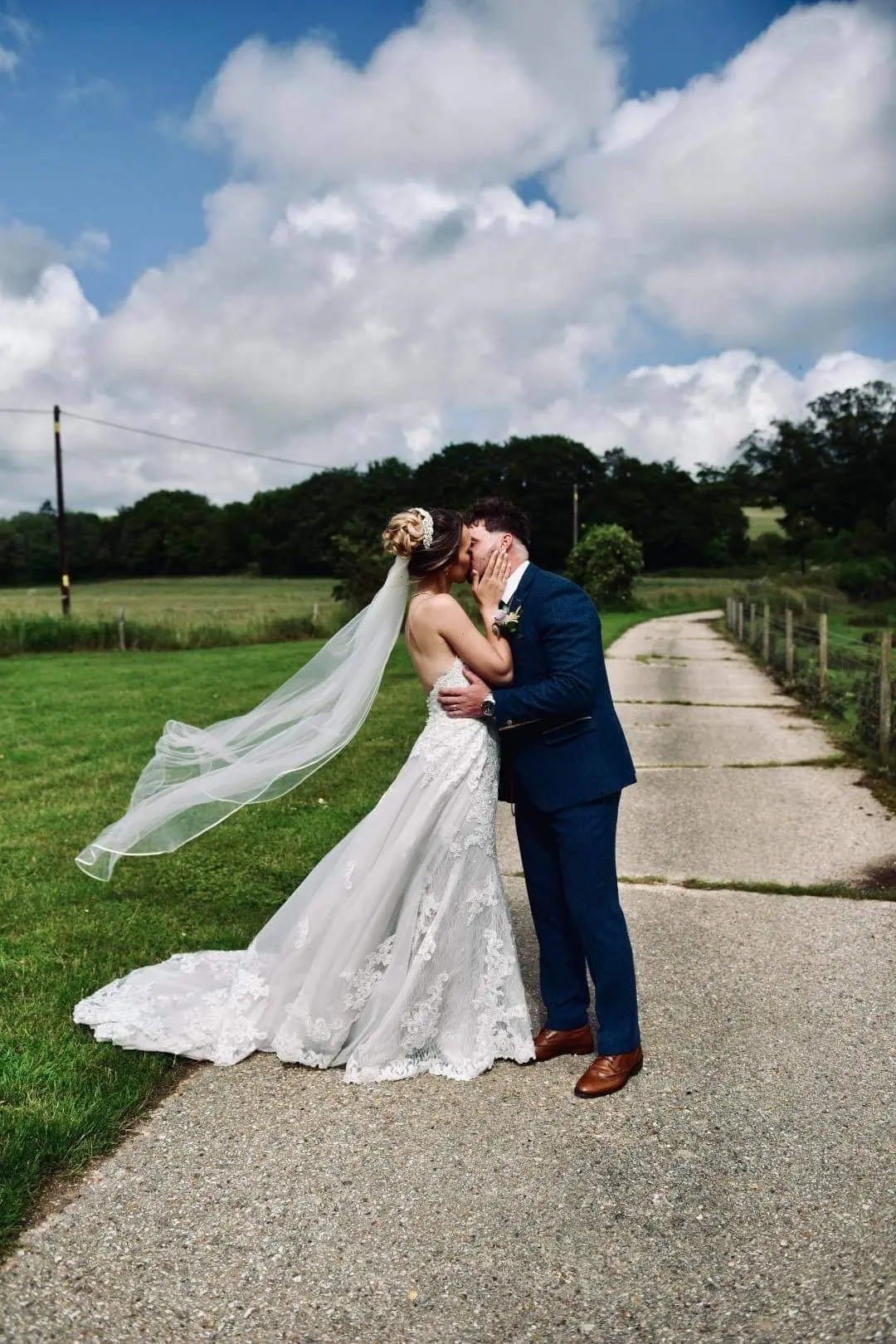bride with groom in lacy mermaid wedding dress