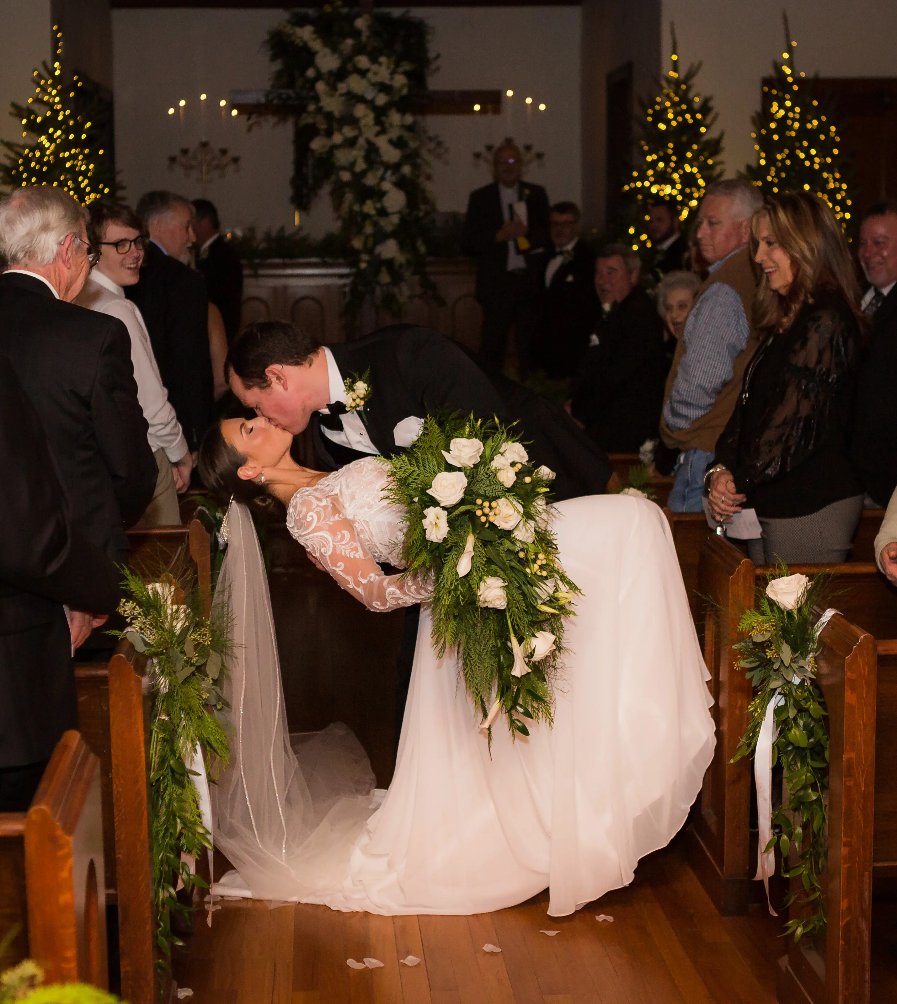 Bride wearing Lorraine Dawn wedding dress by Rebecca Ingram being dipped by her husband at the aisle