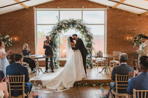 Bride wearing Derrick by Maggie Sottero kissing her husband