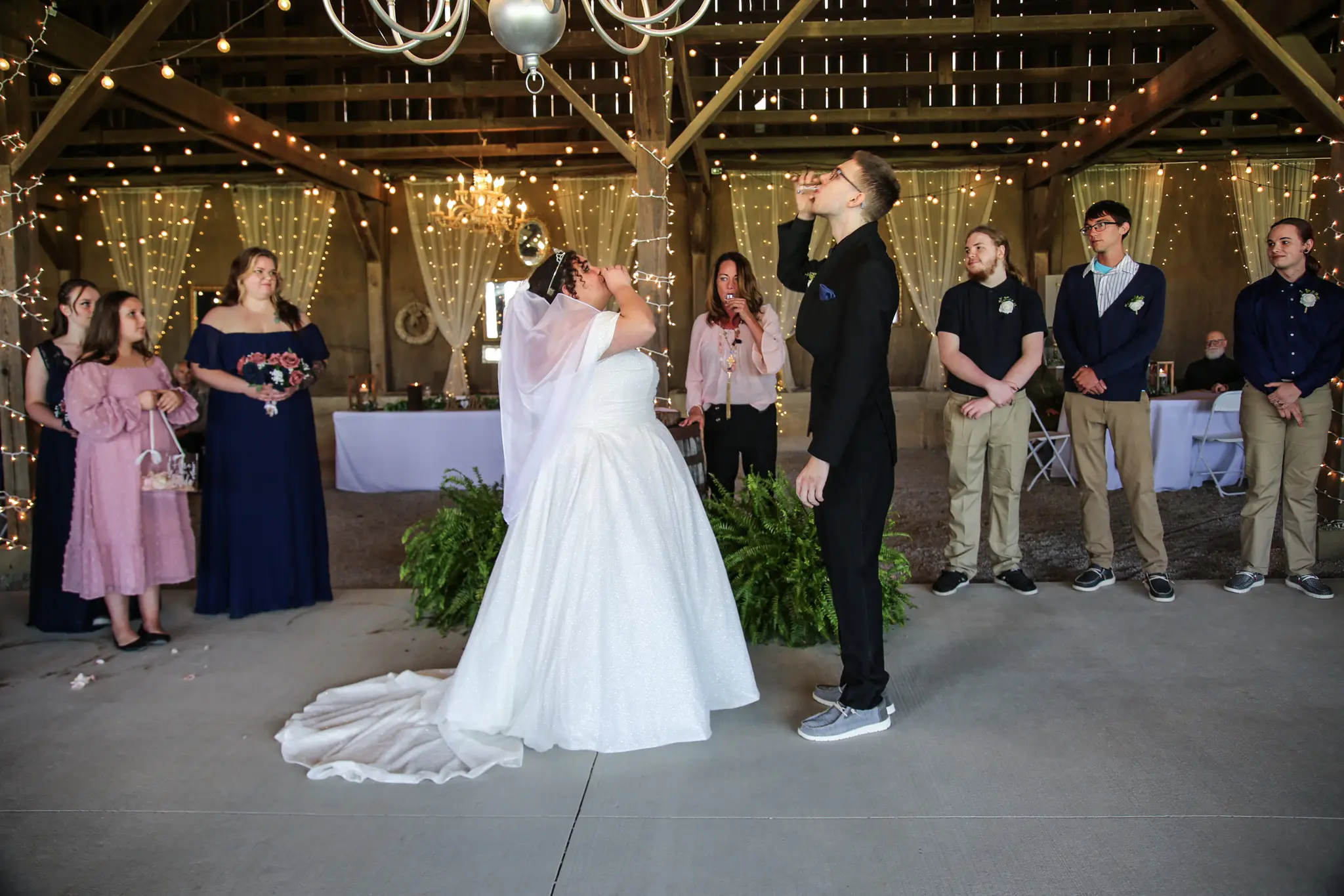 Bride wearing Anniston by Maggie Sottero drinking with her husband
