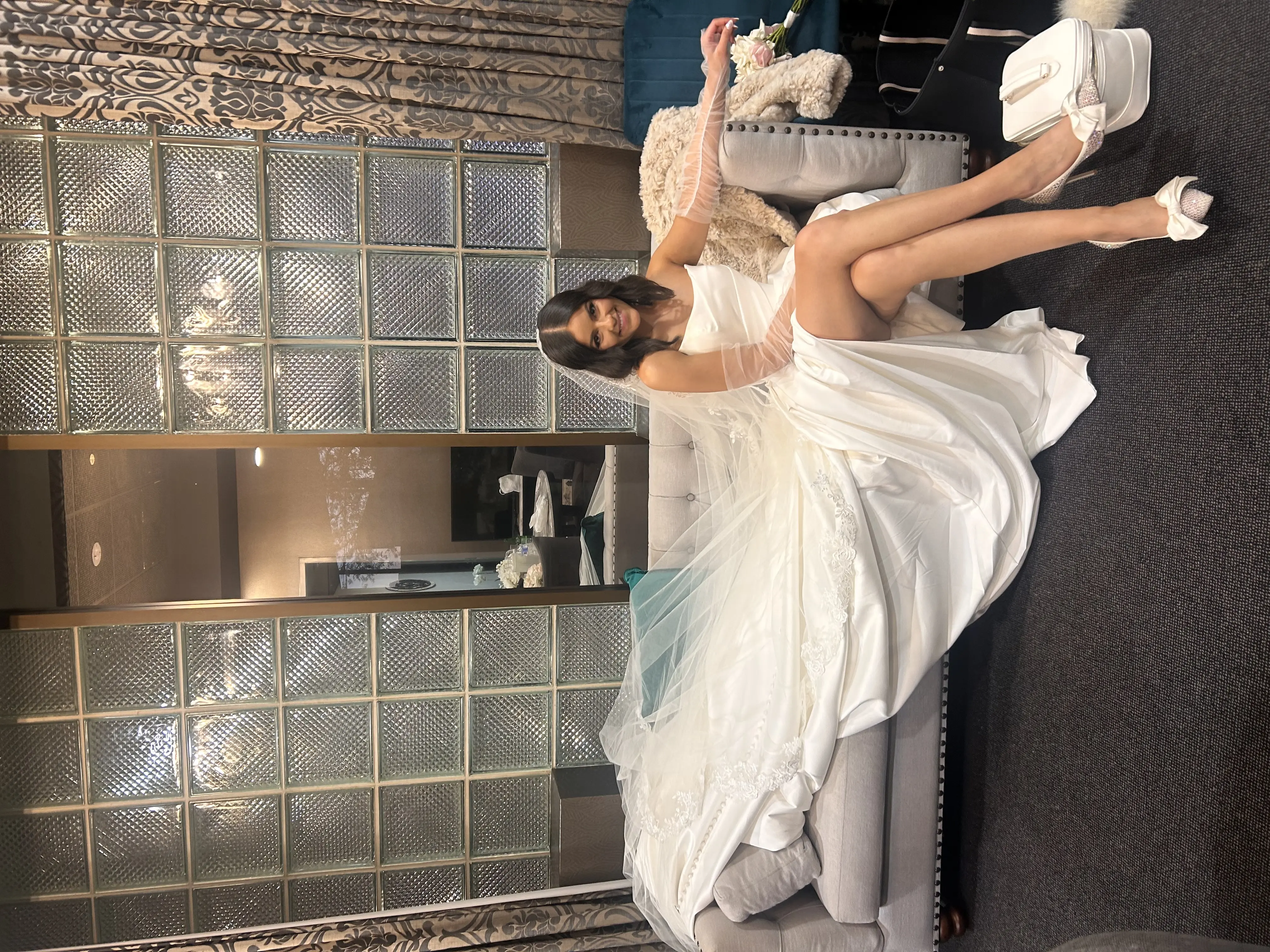 Bride wearing Aspen by Sottero and Midgley on a couch