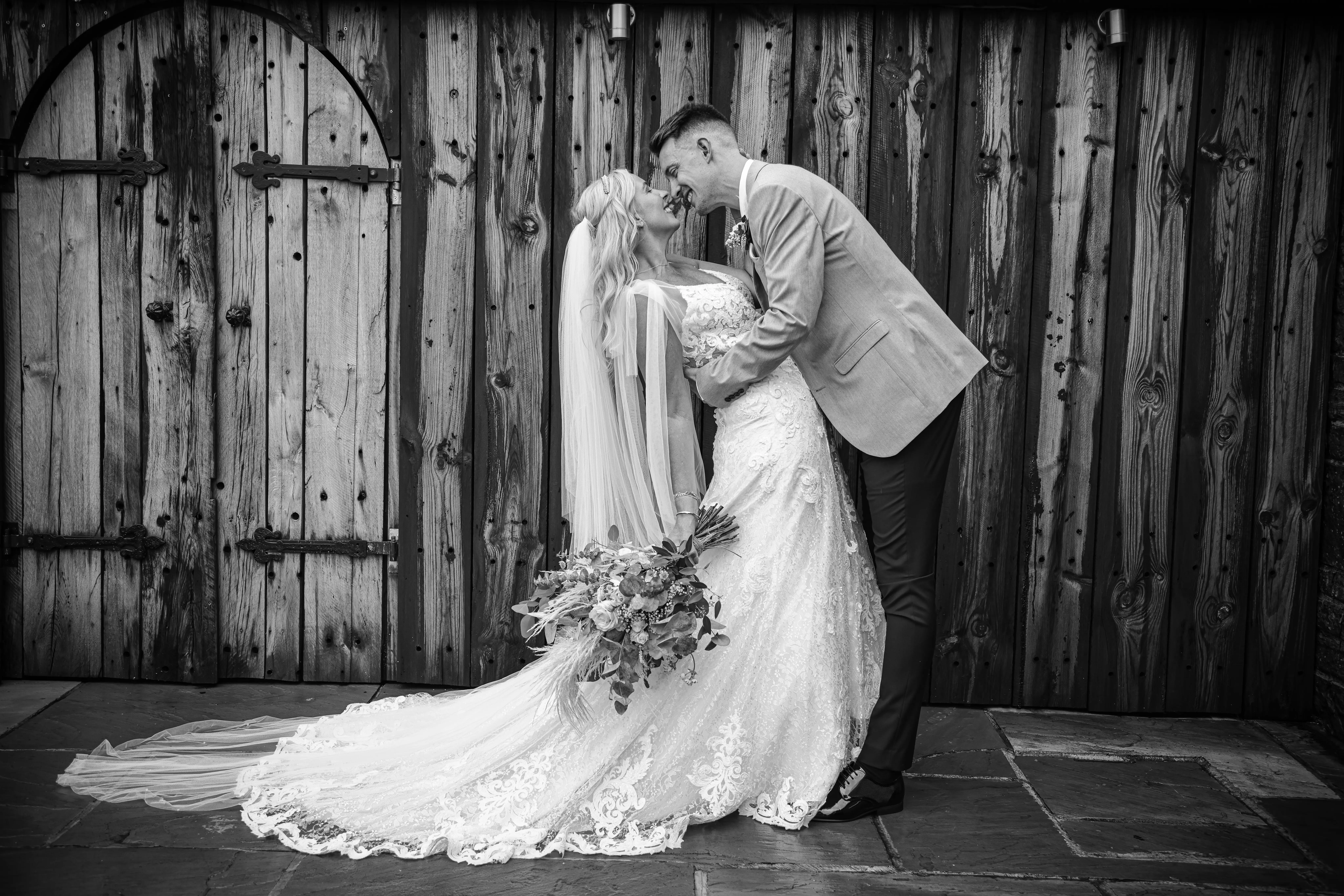 Groom dipping his bride as they look into each others eyes.