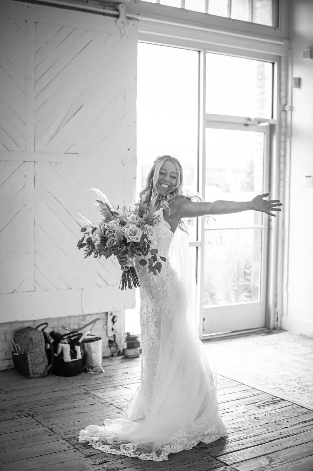 Bride wearing romantic lace sheath wedding dress.