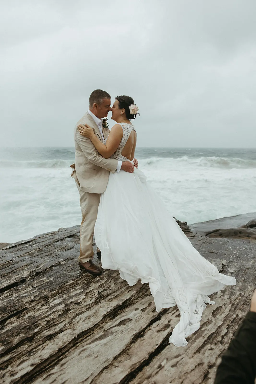 Bride with groom wearing boho wedding dress with keyhole back.