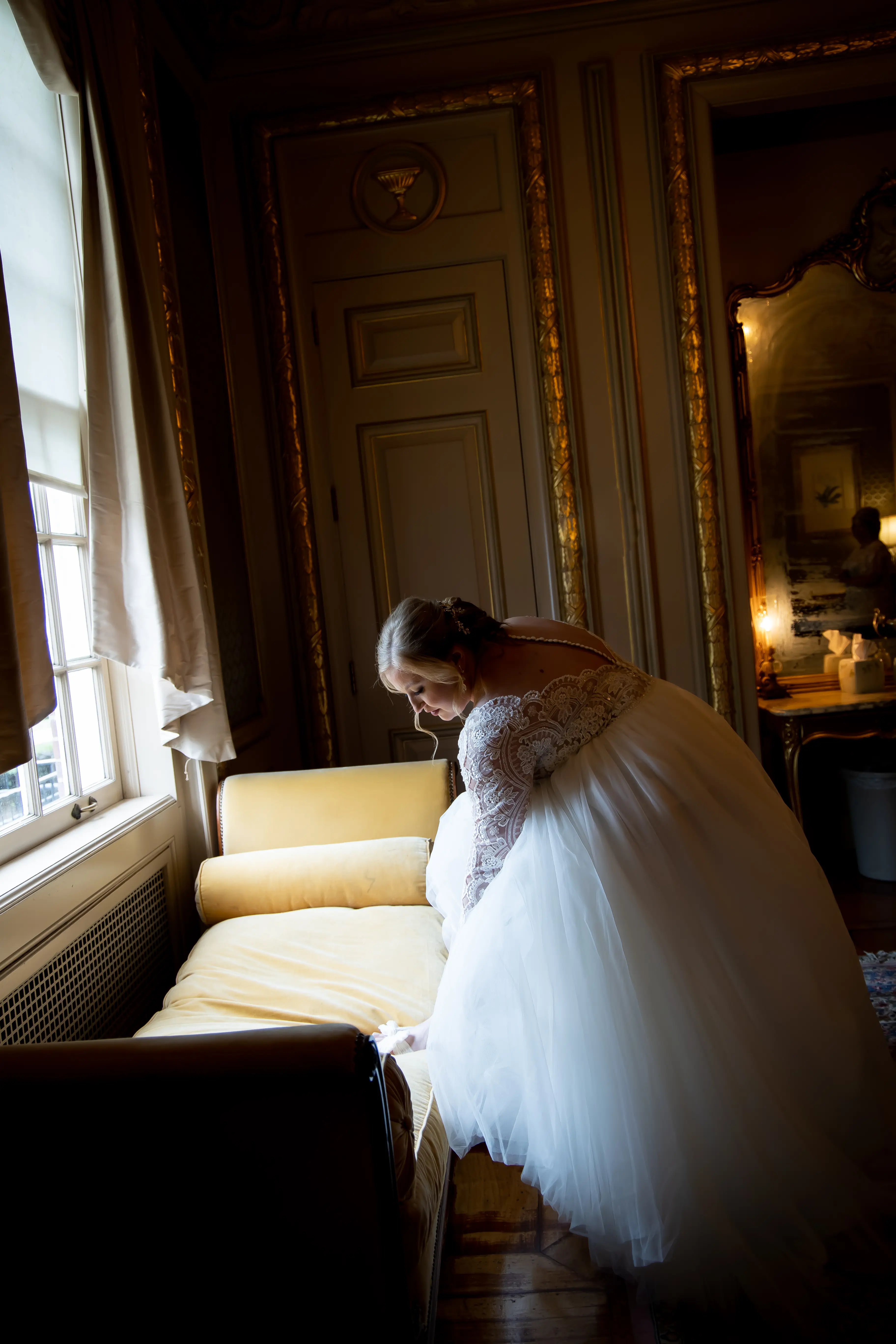 Bride Slipping Shoes On Wearing Bridal Gown Called Mallory Dawn by Maggie Sottero