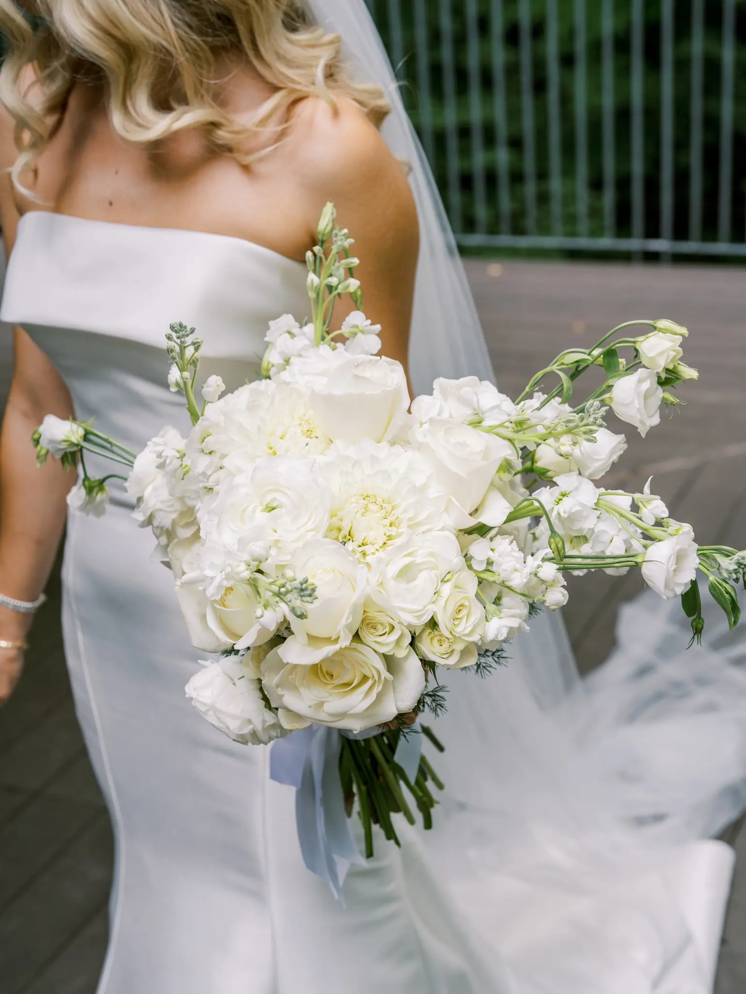 Bride Wearing Simple Fit And Flare Wedding Dress Called Mitchell Marie By Maggie Sottero Holding A White Bouquet