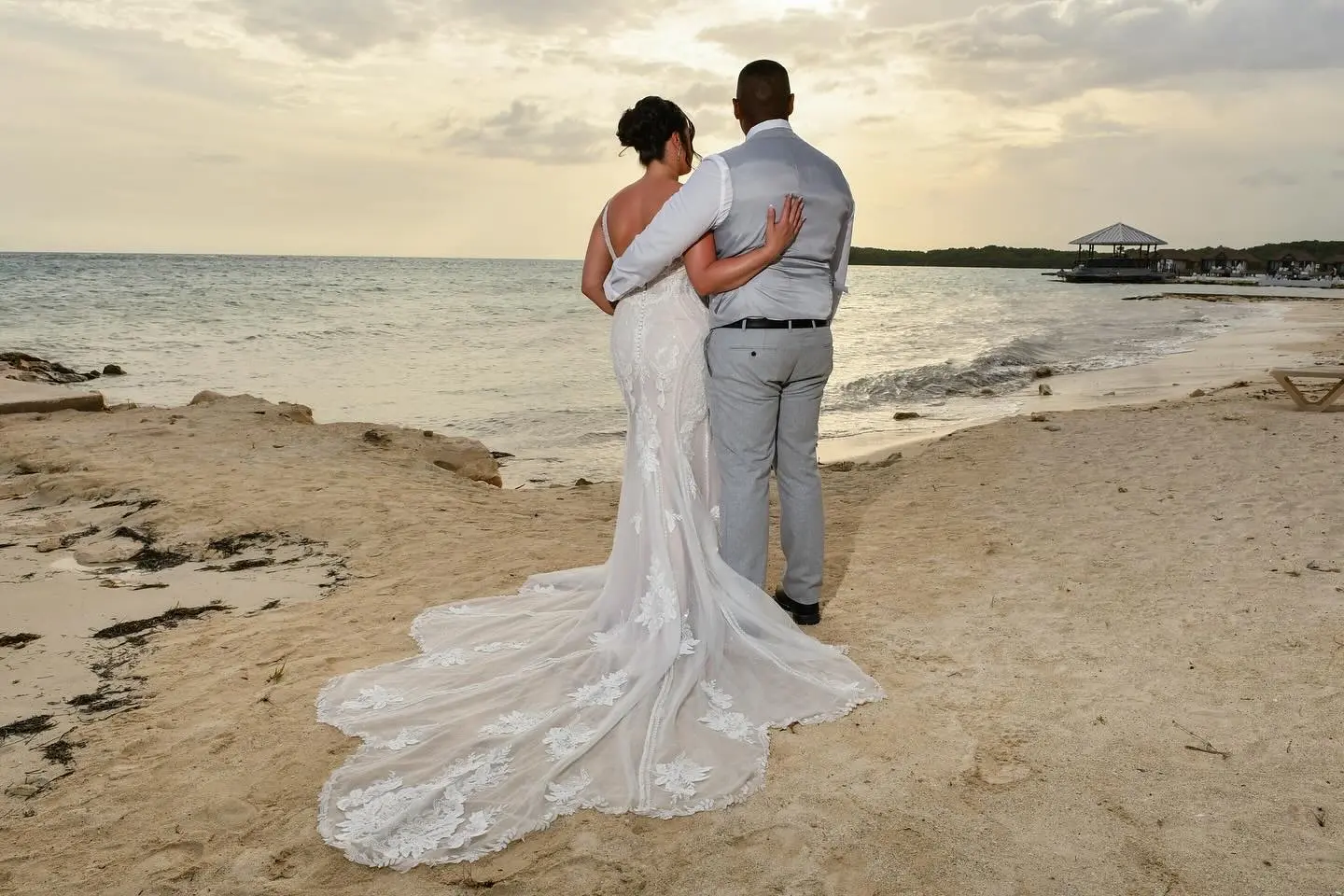 Bride wearing Franklynn by Sottero and Midgley on the beach with her husband