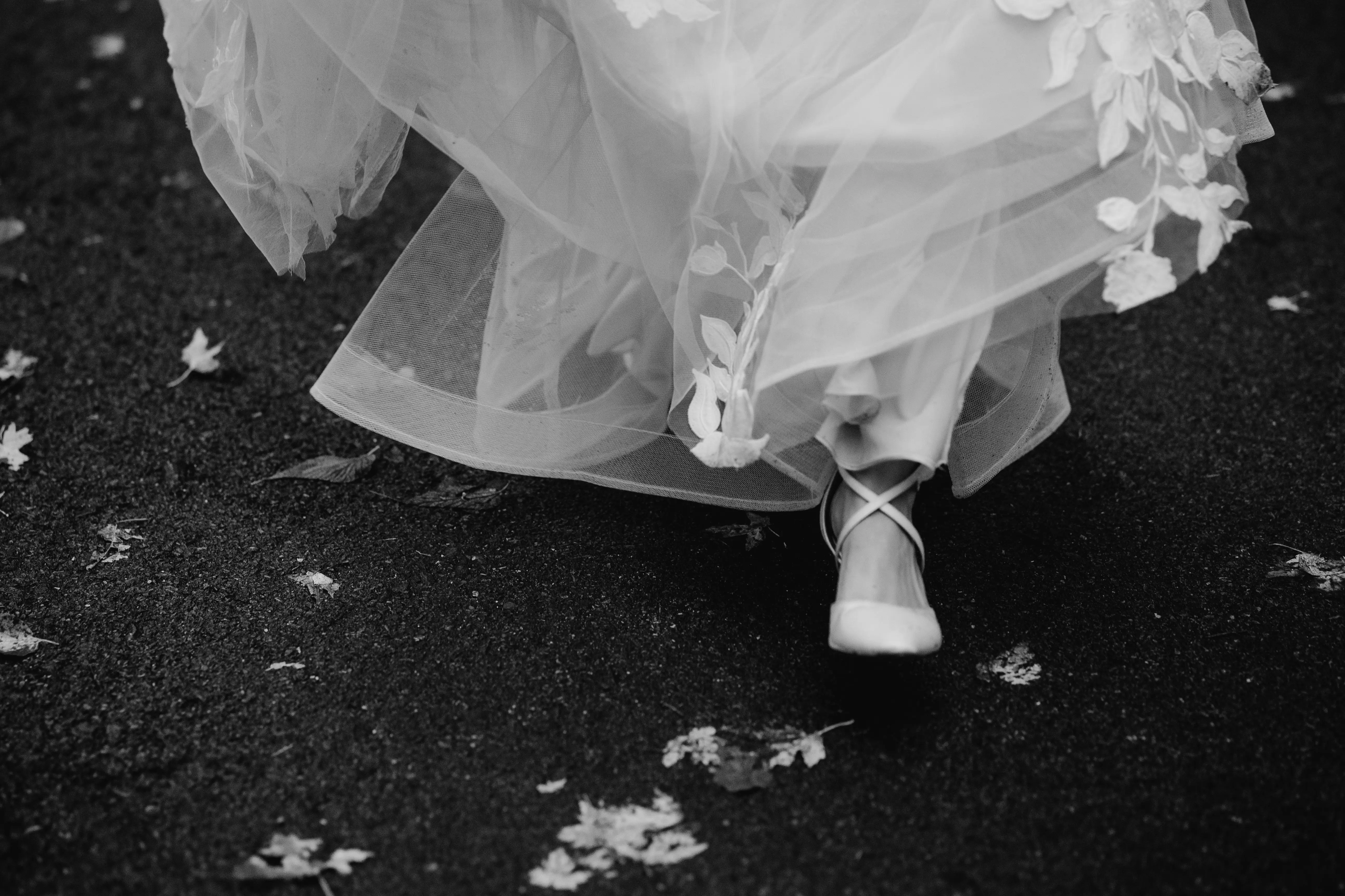Real Bride Walking Wearing A White Wedding Dress Named Hattie By Rebecca Ingram With White Shoes