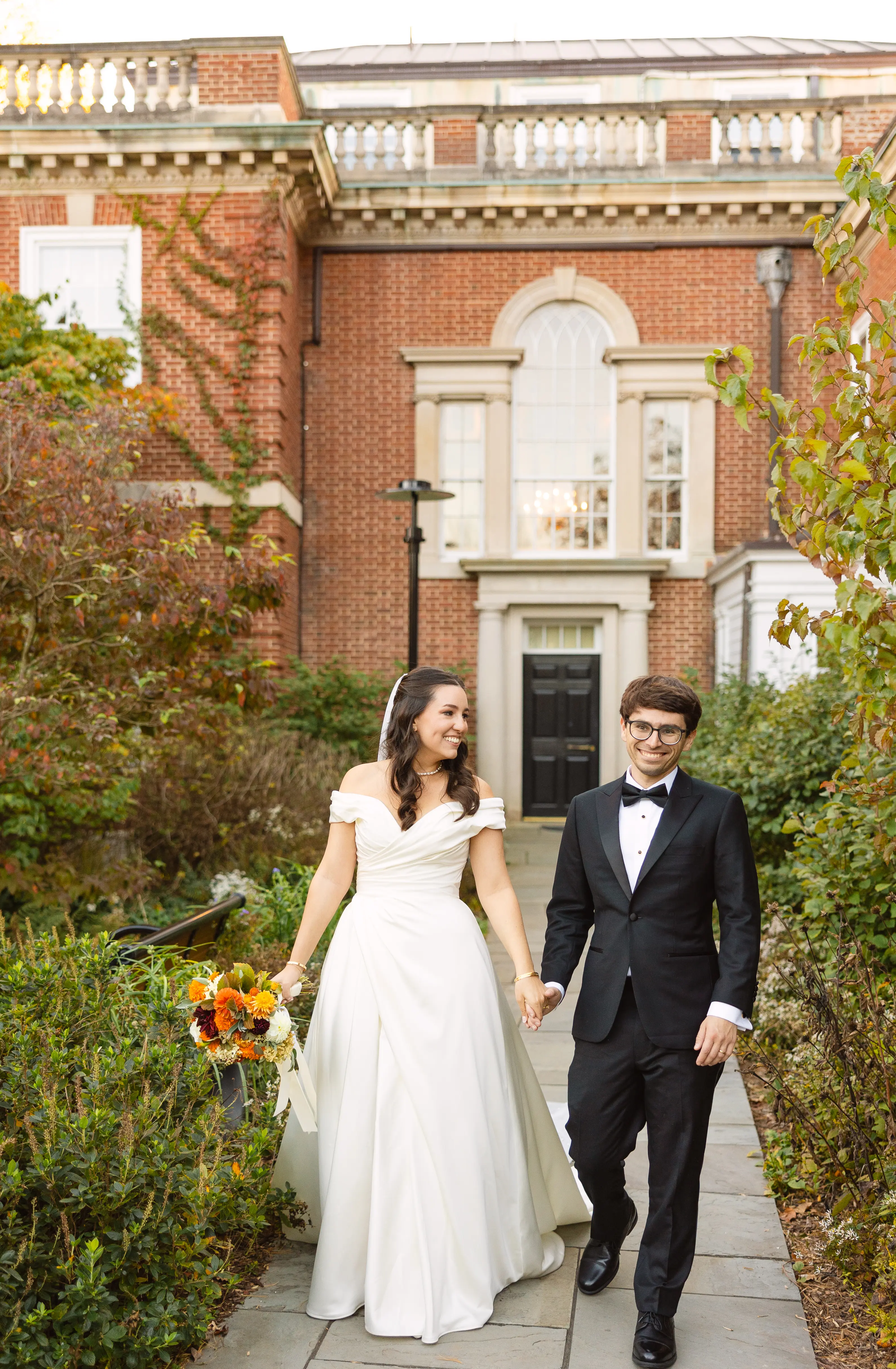 Bride Wearing Satin Aline Wedding Dress Called Ekaterina By Maggie Sottero Holding Hands With Groom