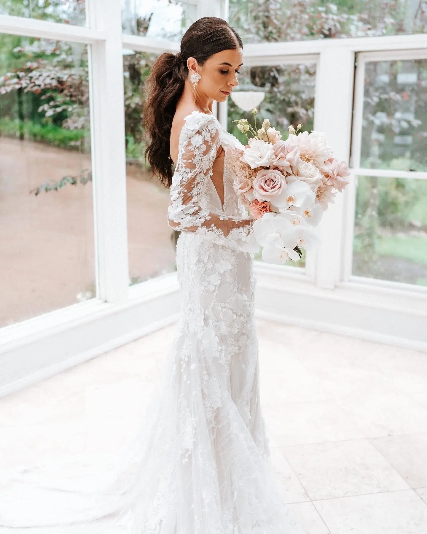 Real Bride wearing puff sleeve wedding dress with 3D floral details called Cruz by Sottero and Midgley..