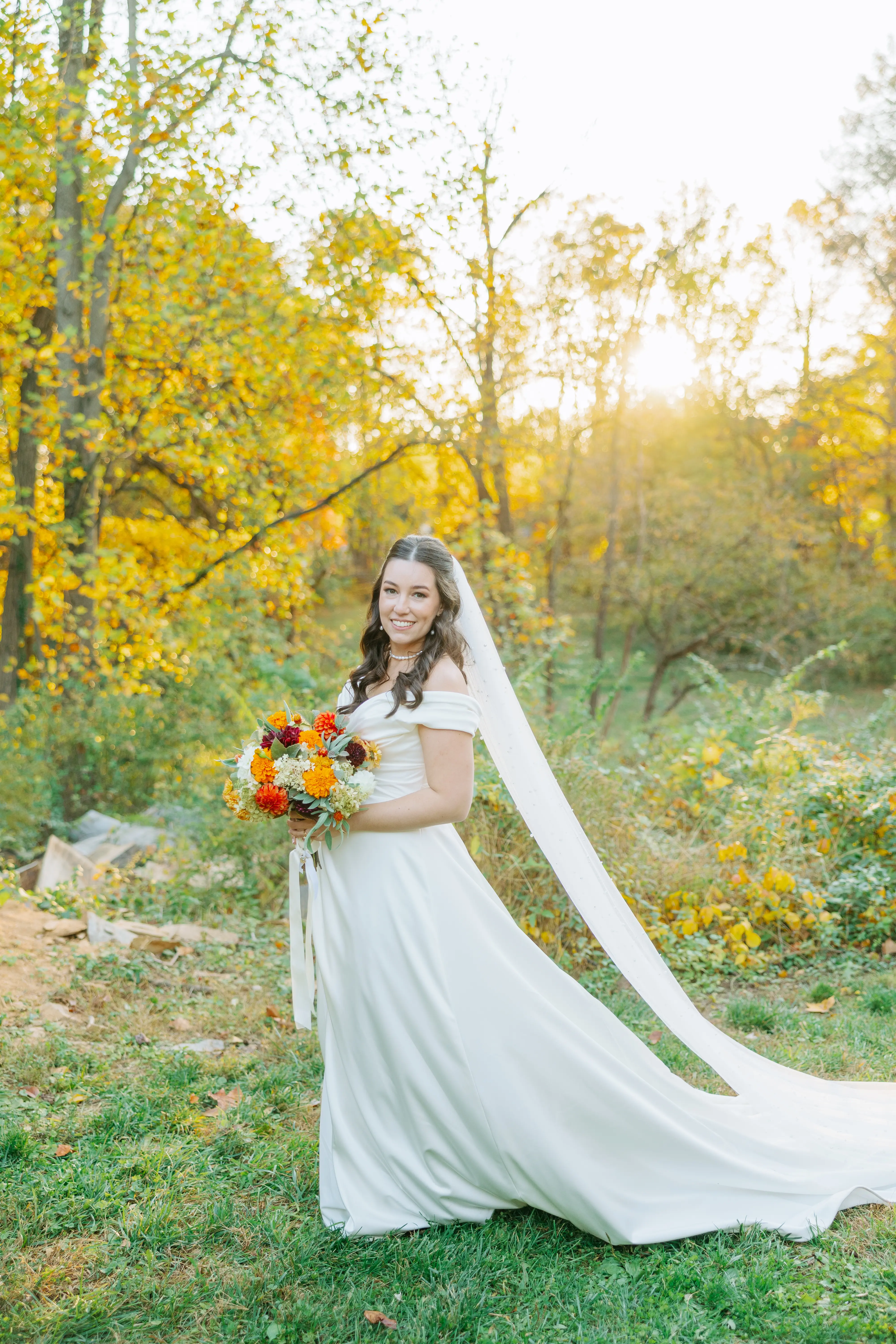 Bride Wearing Satin Aline Wedding Dress Called Ekaterina By Maggie Sottero In A Forest Holding A Bouquet
