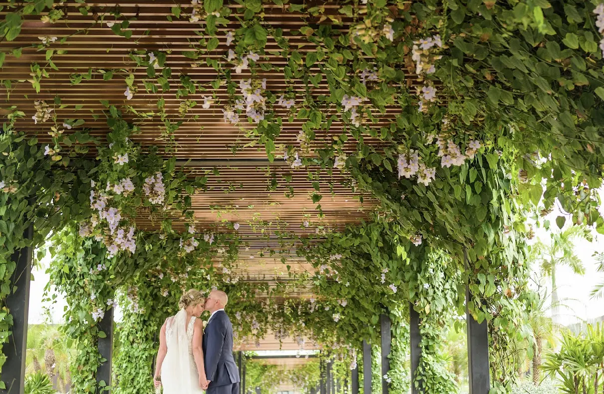 Groom kissing brides forehead.