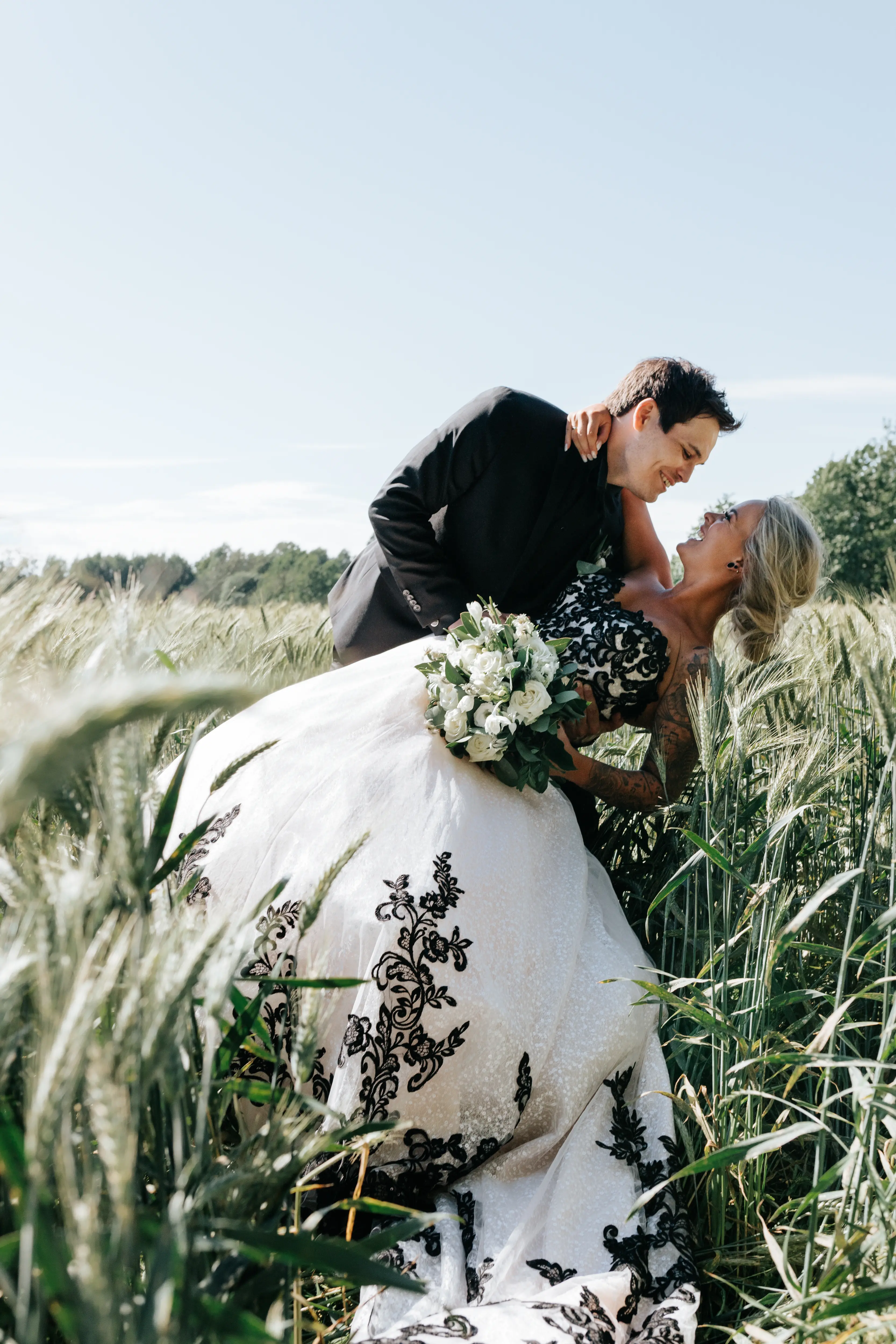 Groom With Bride Wearing Ballgown With Black Lace Detail Called Tristyn By Maggie Sottero