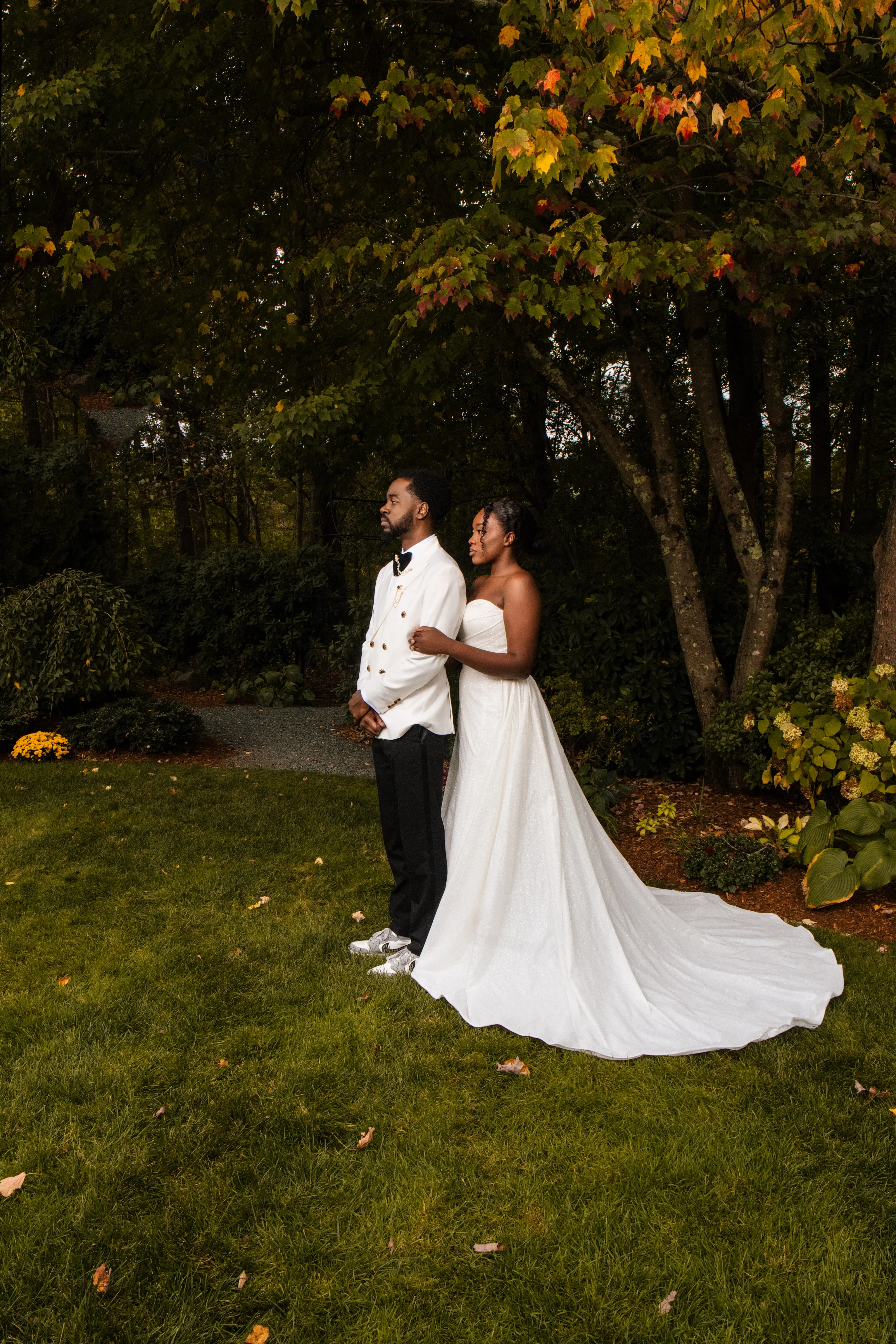 Bride Wearing Simple Fit and Flare Wedding Dress Called Anniston Lane Holding Groom In A Green Garden