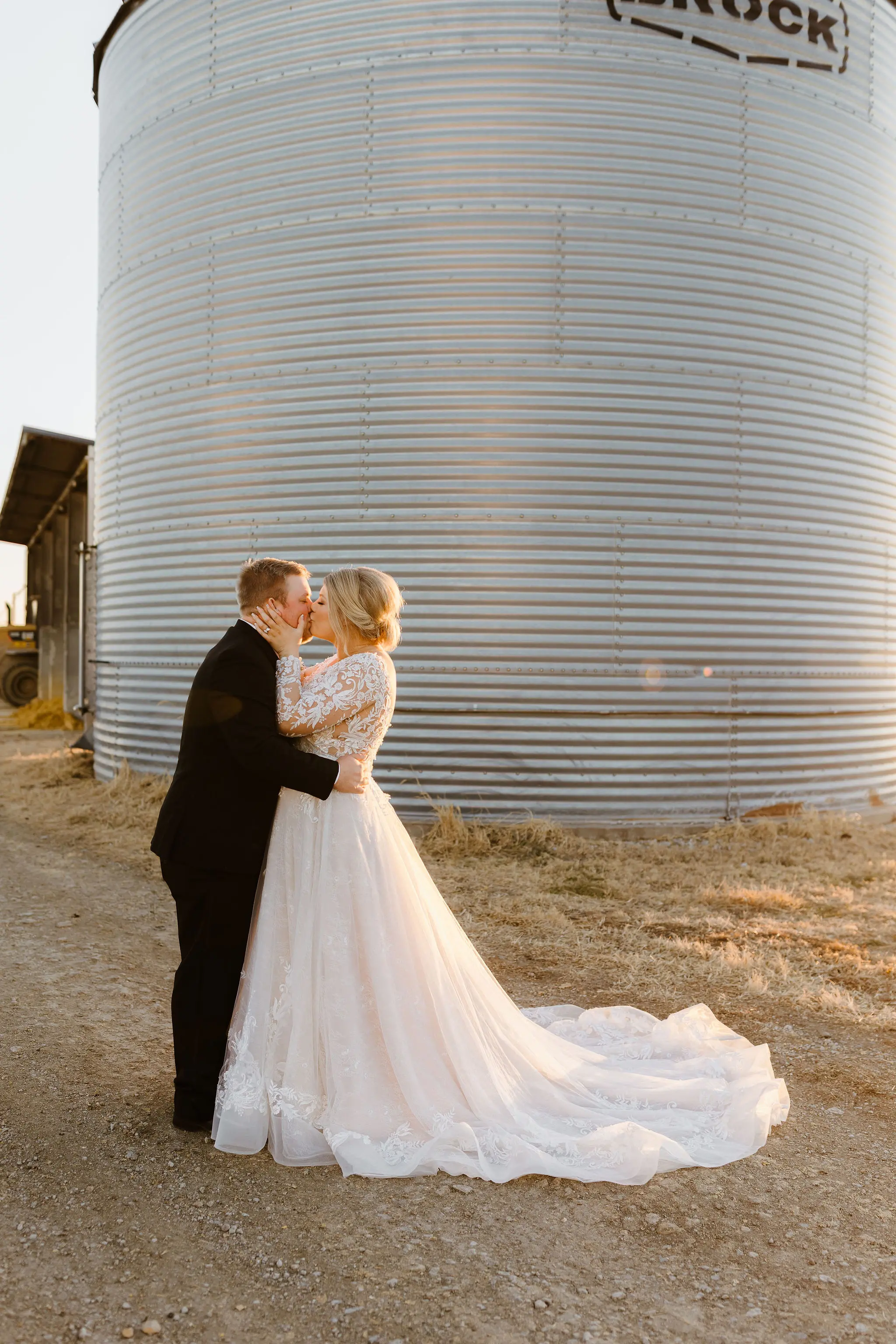 Bride And Groom Share A Kiss. Bride Wearing Layered Tulle And Lace Ballgown Called Zander By Sottero And Midgley