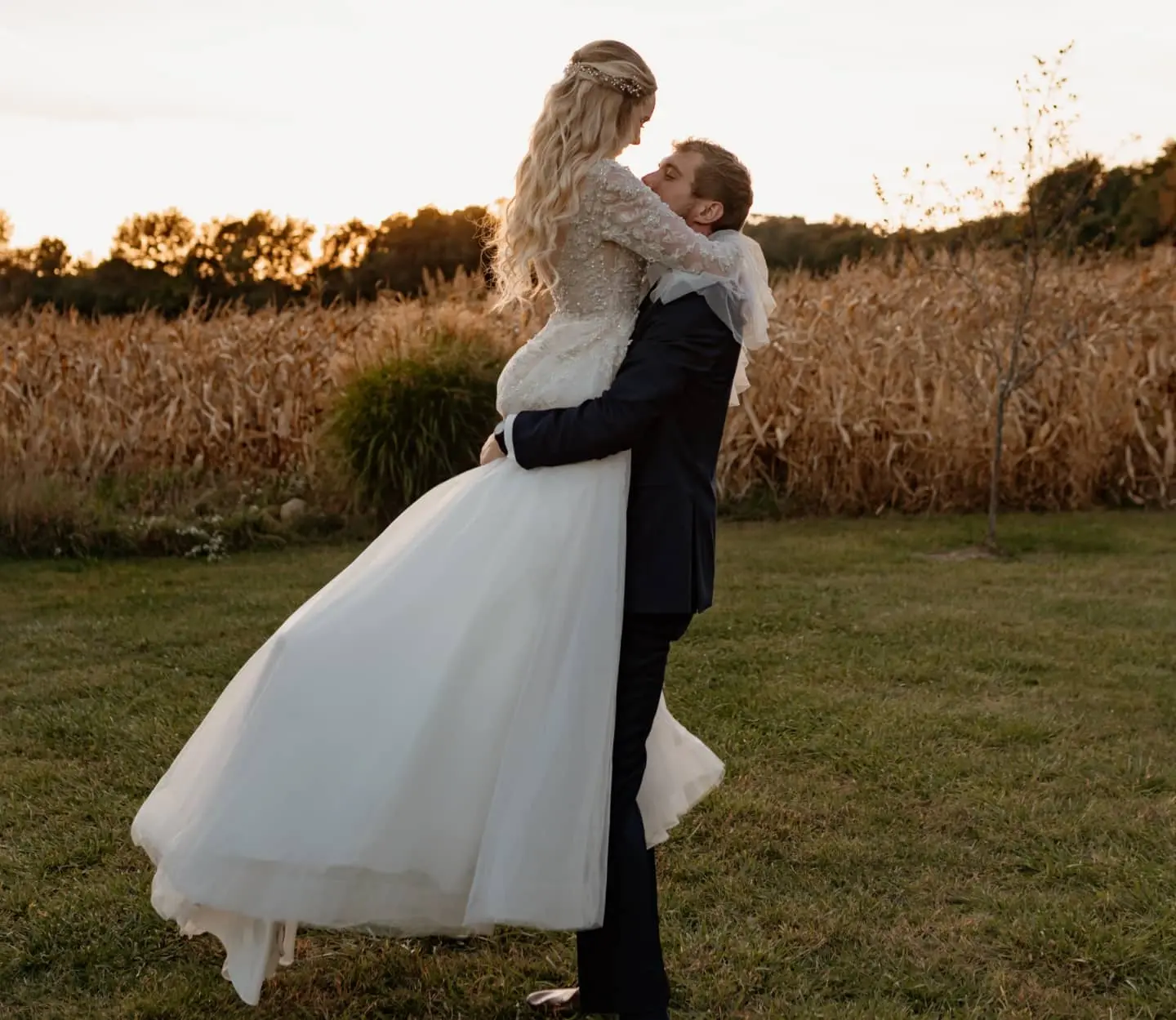 Groom lifting his bride who is wearing wedding dress called Talia.