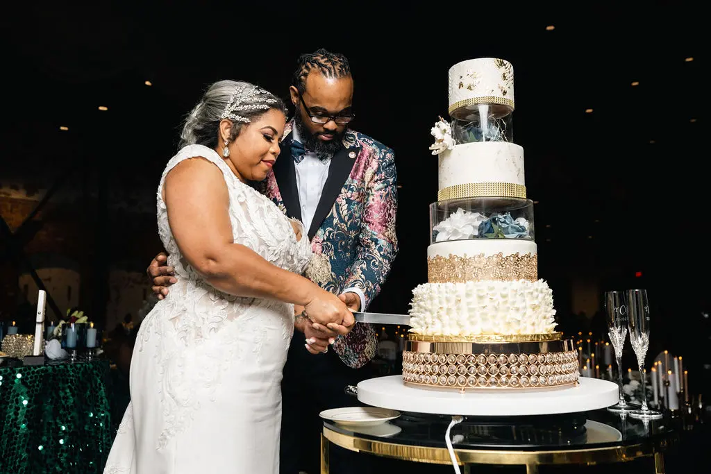 Bride Wearing Chic Crepe Wedding Gown Called Anson By Sottero And Midgley And Groom Cutting The Cake