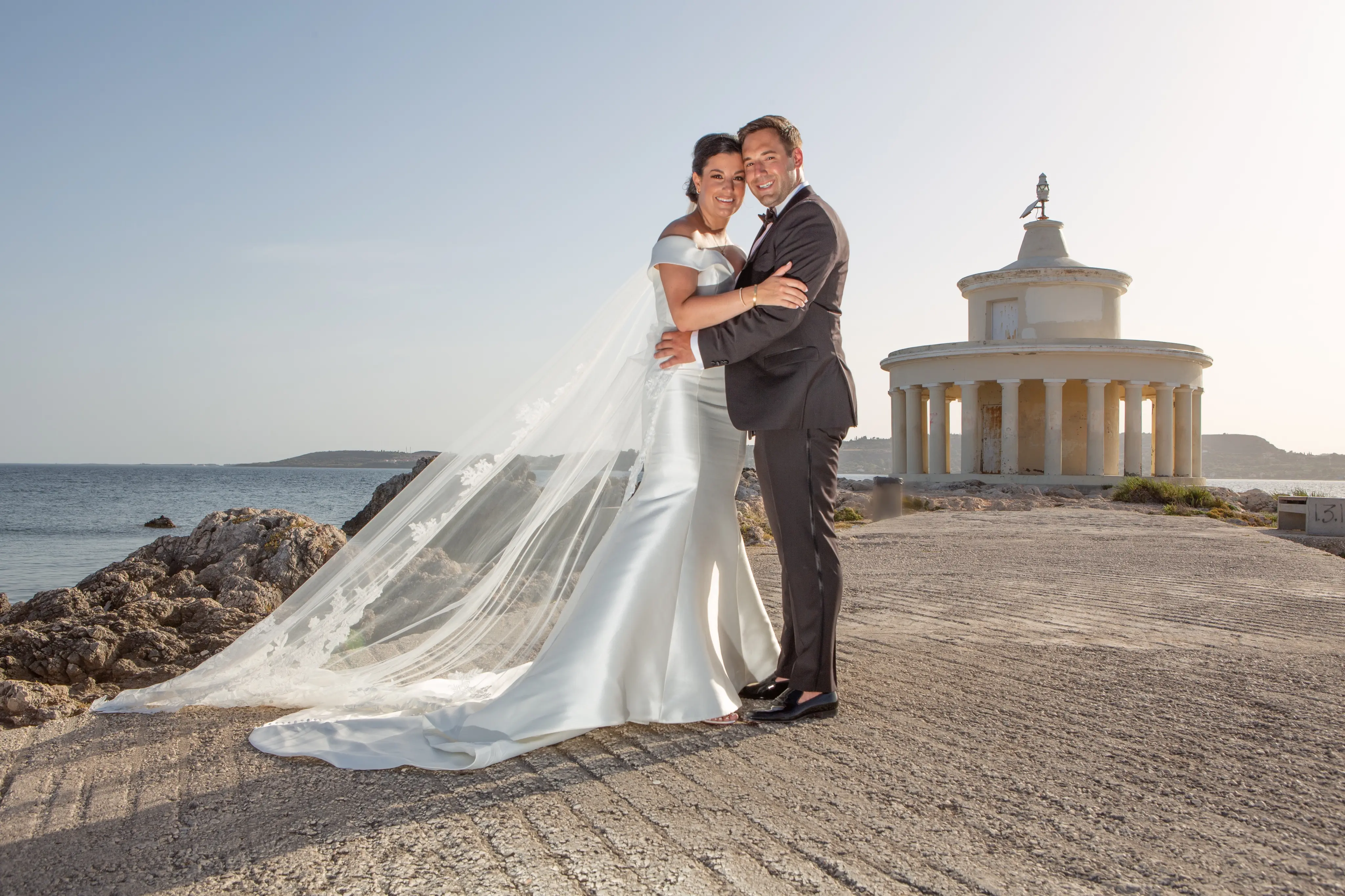Bride wearing Simple Fit-and-Flare Wedding Dress called Josie by Rebecca Ingram on the beach with the groom