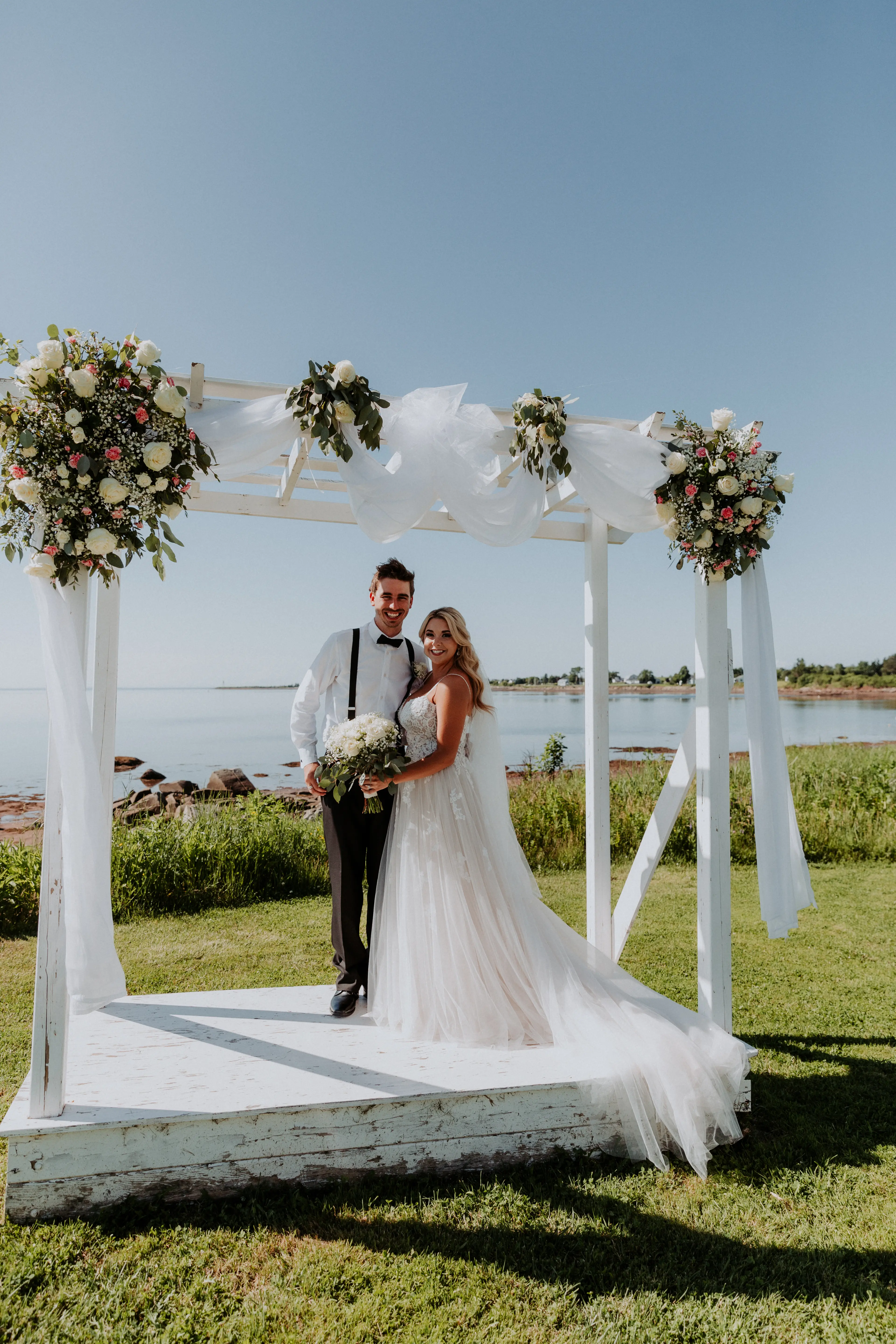 Groom with Bride in Flattering A-Line Spaghetti Strap Wedding Dress with Romantic Lace Called Marisol by Rebecca Ingram