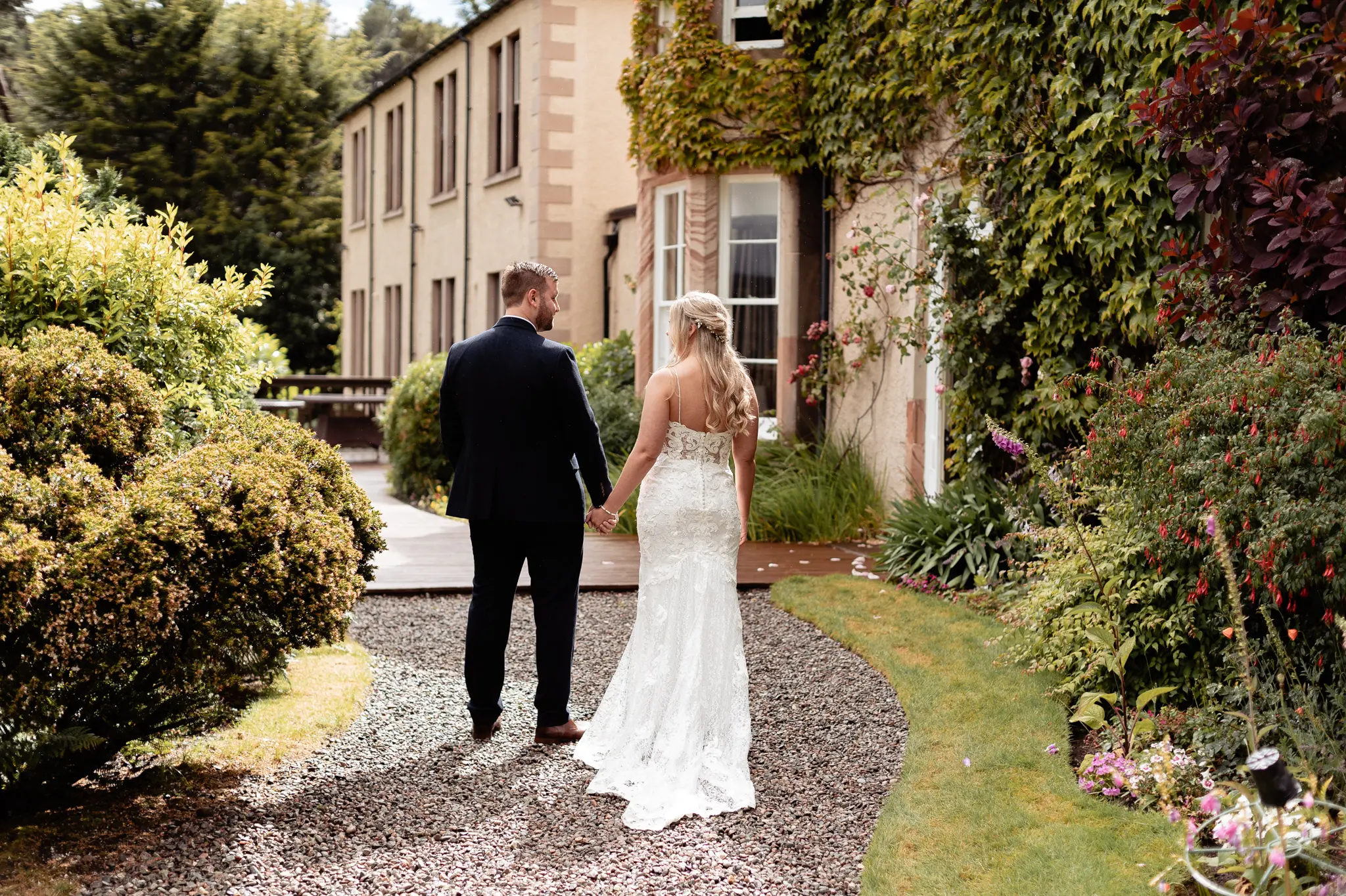 Groom with Bride in Romantic Lace Sheath Wedding Gown with Shimmering Lace Motifs Called Tuscany Lynette by Maggie Sottero