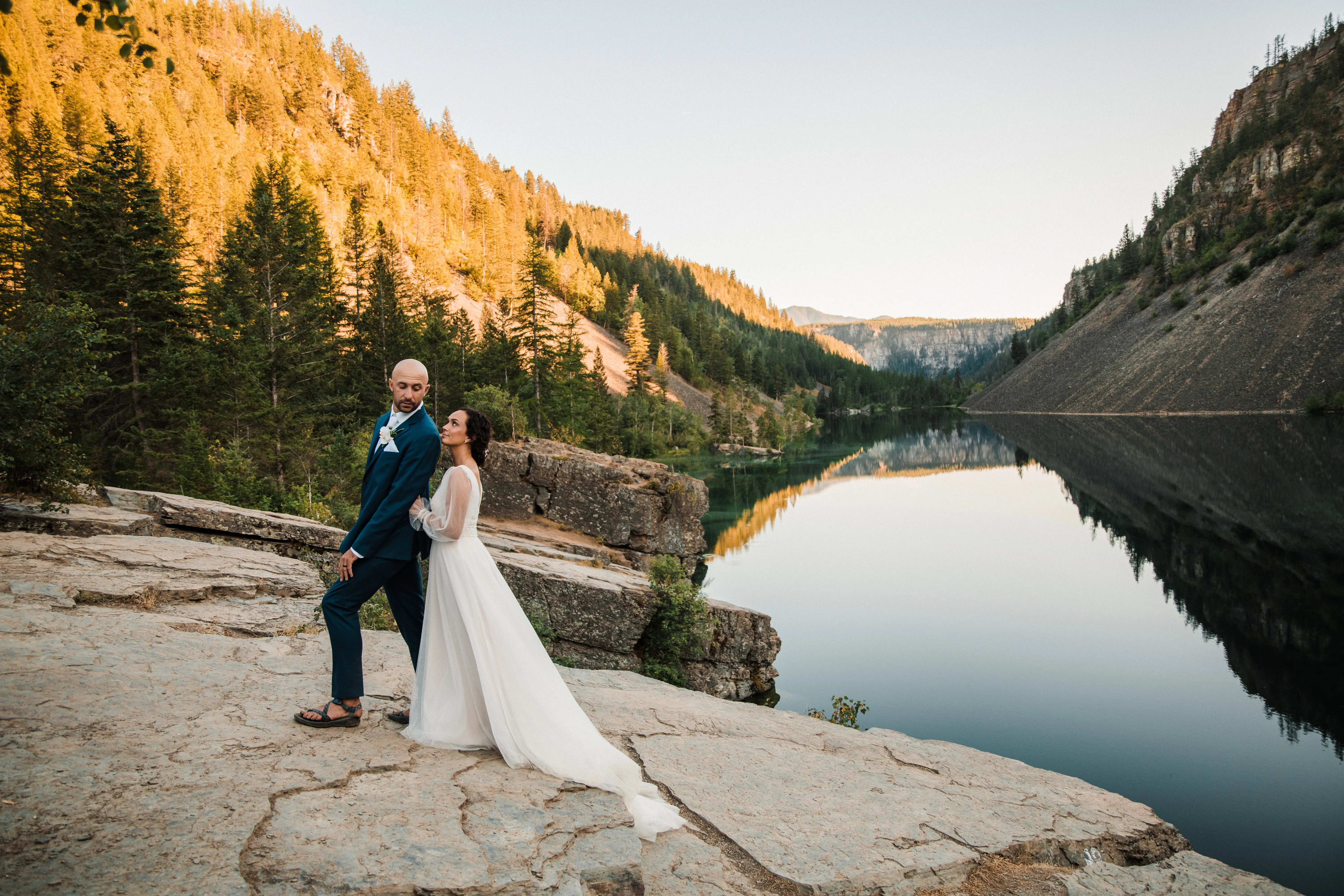 Groom and Bride by Lake in the Mountains Wearing Wedding Dress Called Joanne by Rebecca Ingram.