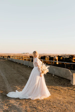 Bride Wearing Long Sleeve Ballgown Called Zander By Sottero And Midgley