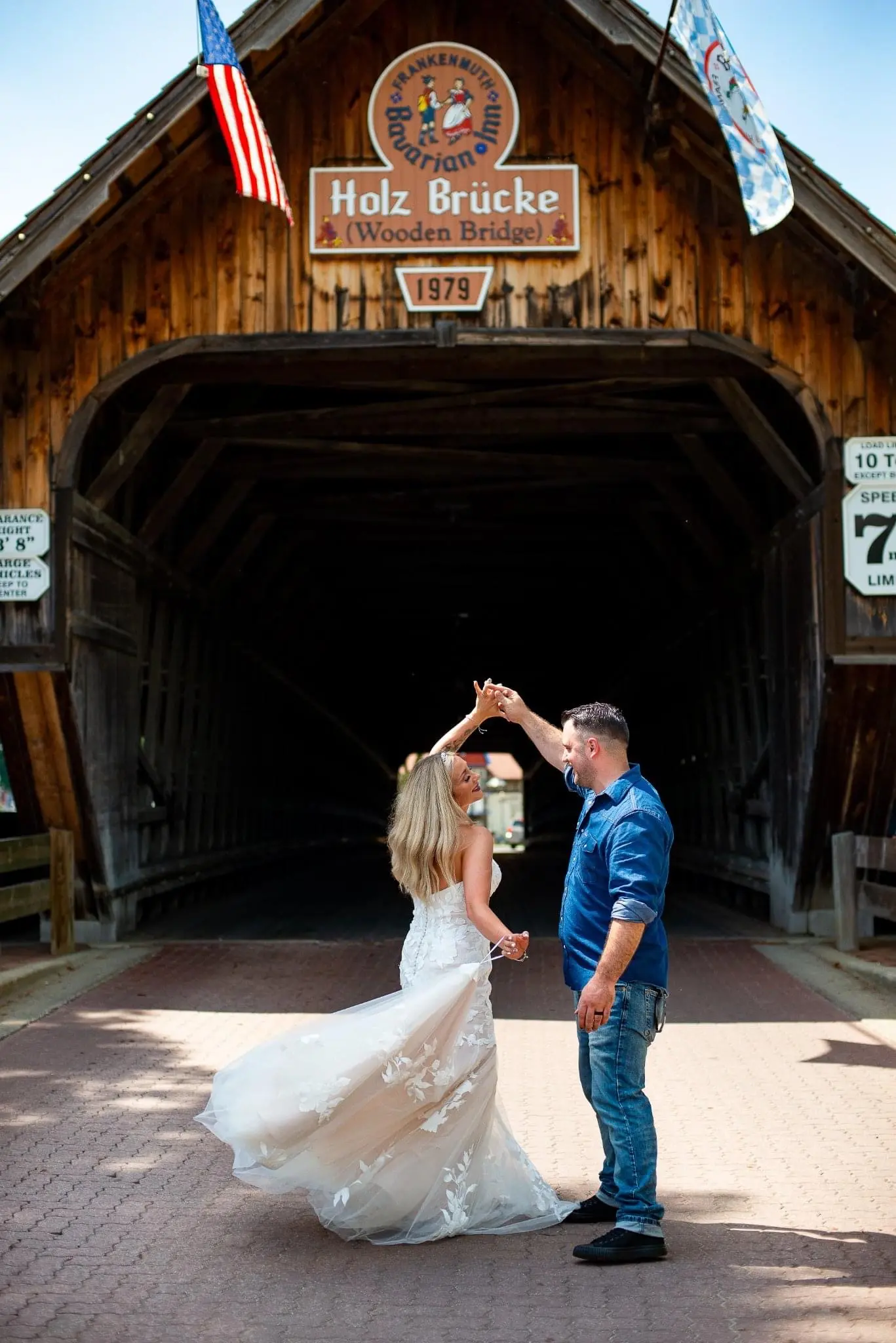 Bride Wearing Lace Strapless Mermaid Wedding Dress Called Hattie By Rebecca Ingram Dancing With Groom By Covered Bridge