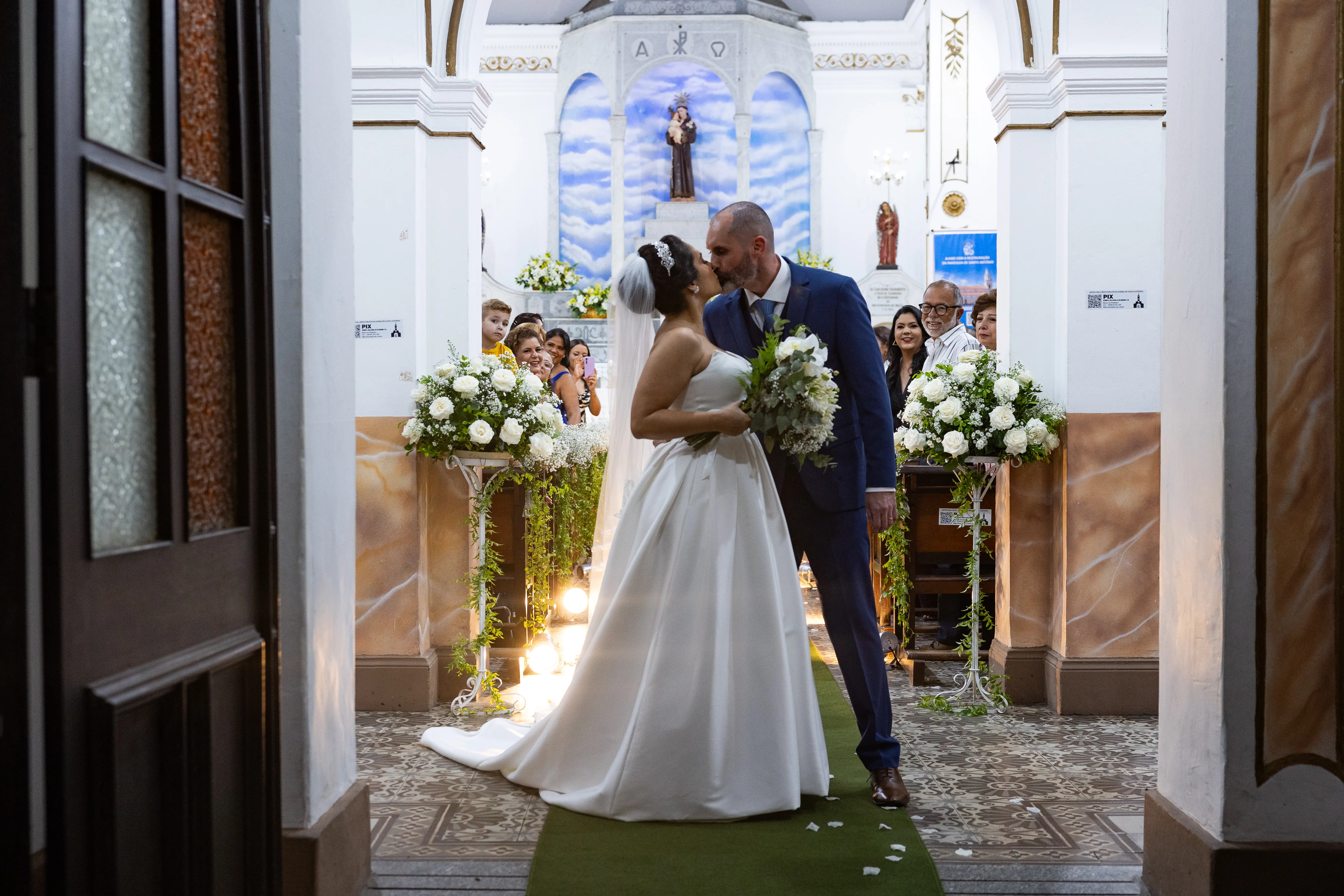 Bride wearing Aspen wedding dress by Sottero and Midgley kissing her husband