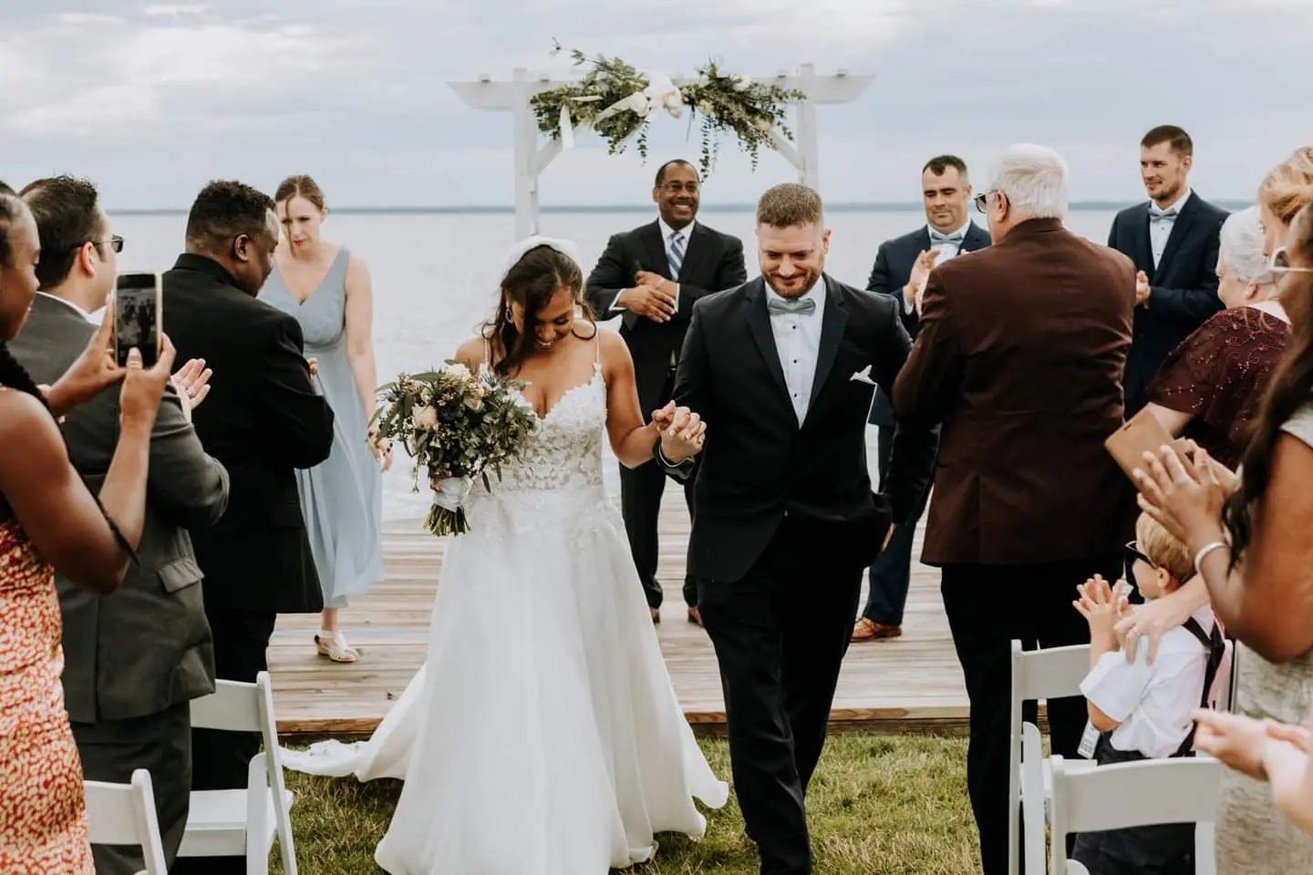 Bride Wearing Flirty A-line Wedding Gown Called Savannah By Maggie Sottero and Groom Walking Down the Aisle